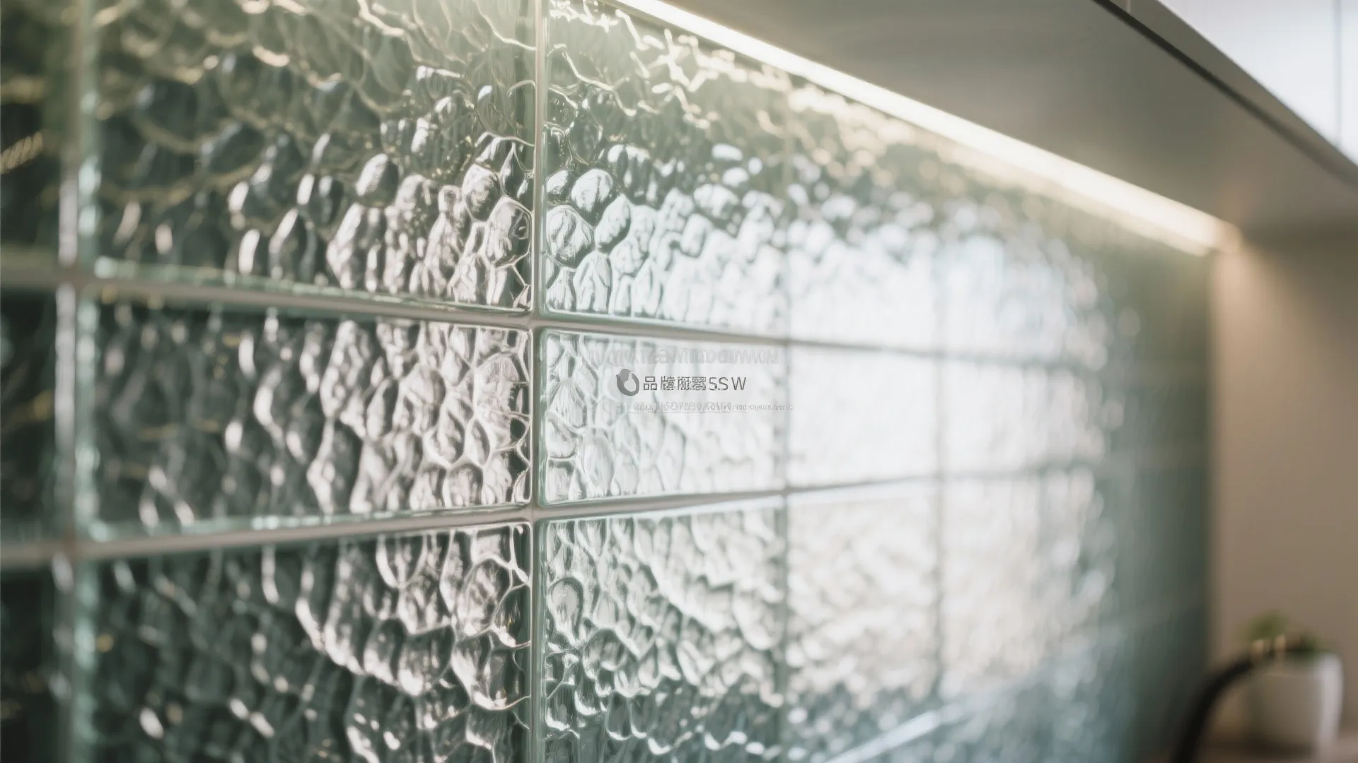Close up view of textured glass wall tiles in a kitchen with soft overhead lighting