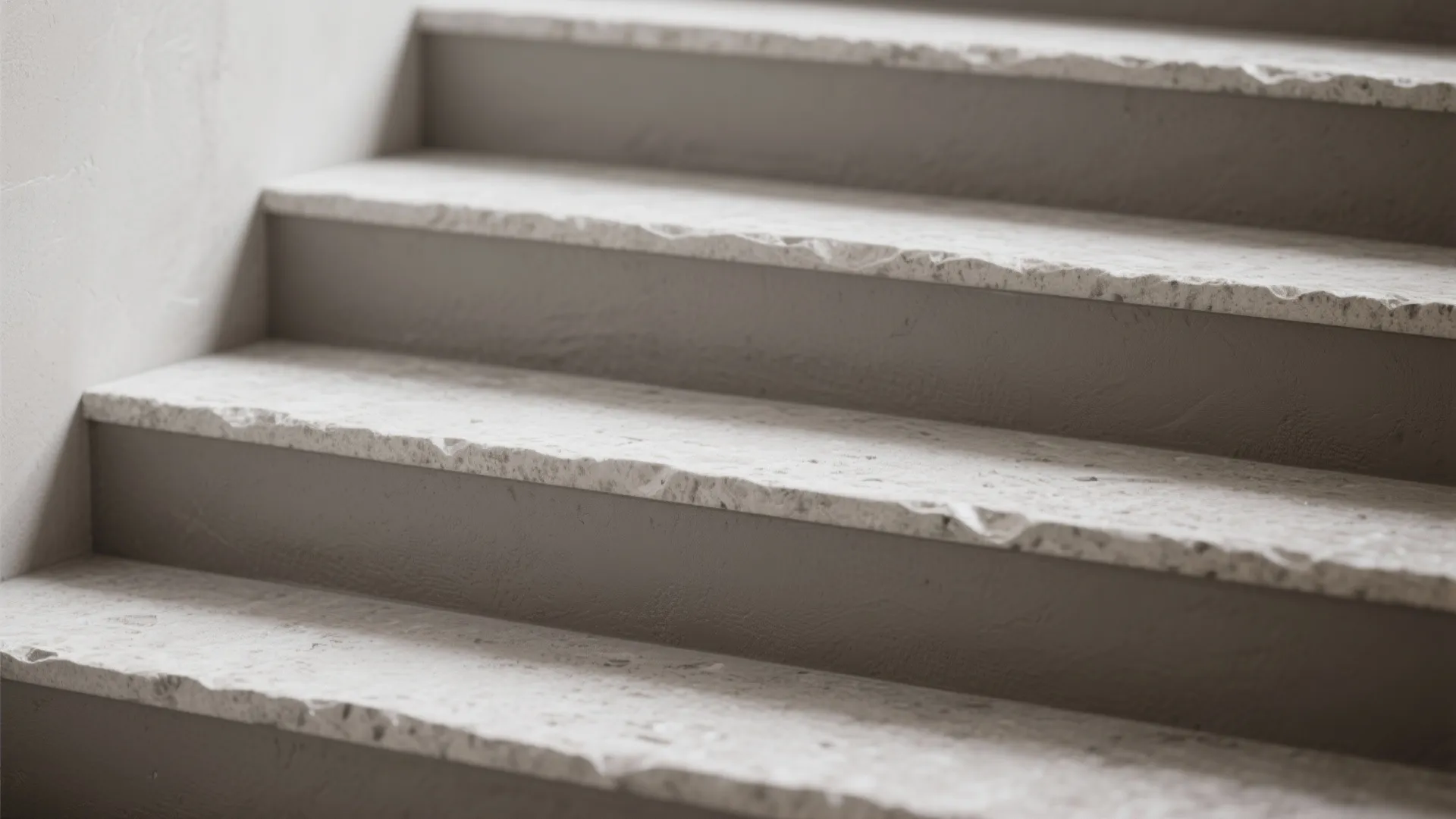 Close up of stone stairs showing textured gray steps with rough edges and simple minimalist look