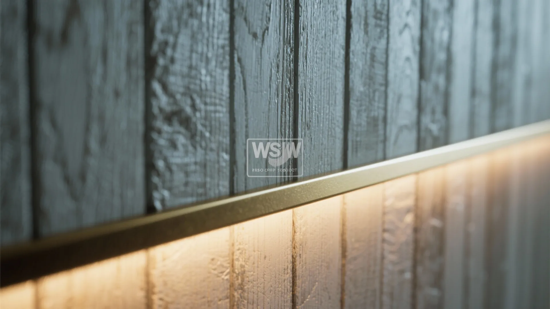 Close up of gold metal trim with warm led light strip on grey wood wall panels