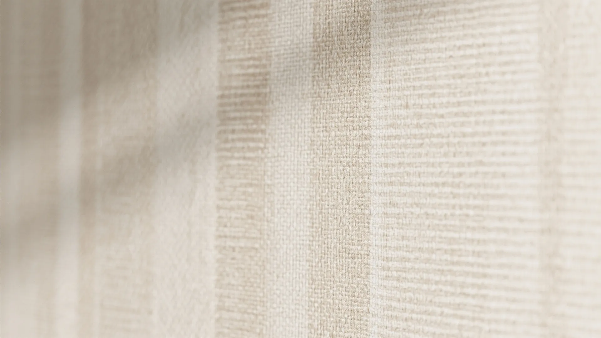 Close up of beige textured wallpaper with vertical stripes and soft shadows in natural light