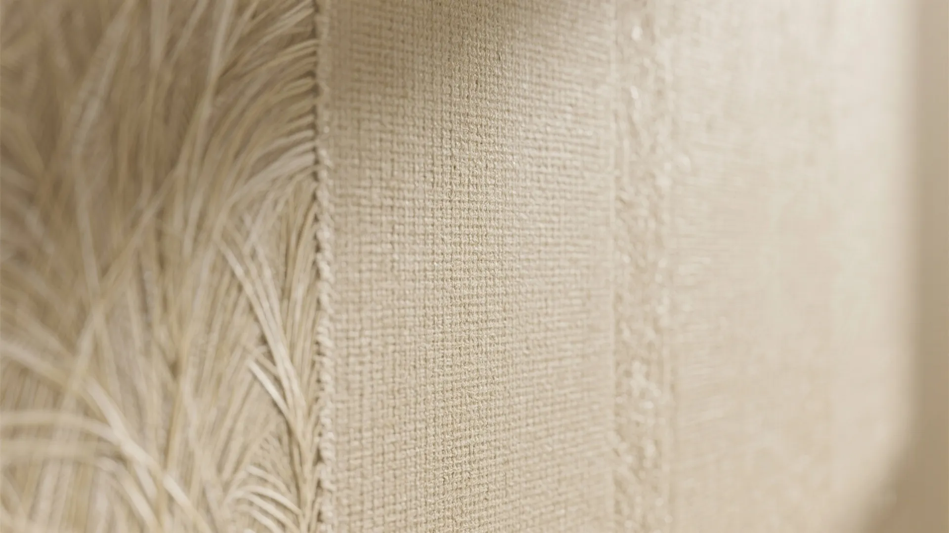 Macro detail of washable textured neutral wallpaper that mimics grasscloth for warmth and durability.