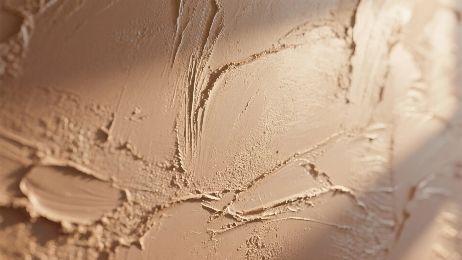 Close up view of beige wall panel material with thick textured brush strokes and shadows