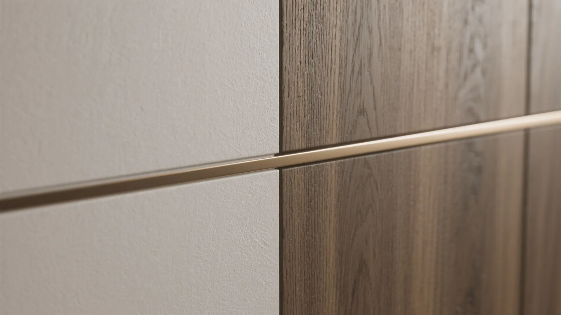 Close-up of white wall panels and dark wood cabinet door with a slim metal strip