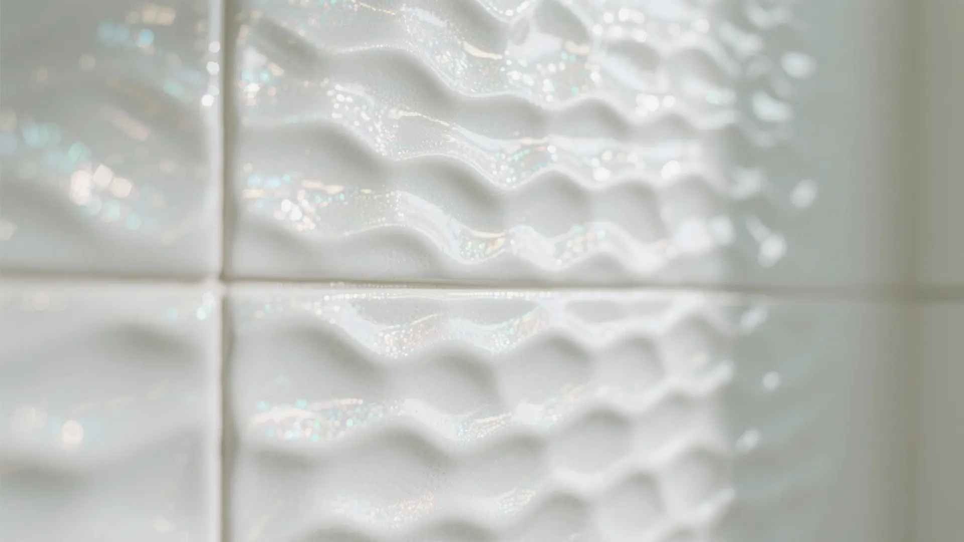 Close up of white textured wall tiles with wave pattern and glossy finish for modern bathroom