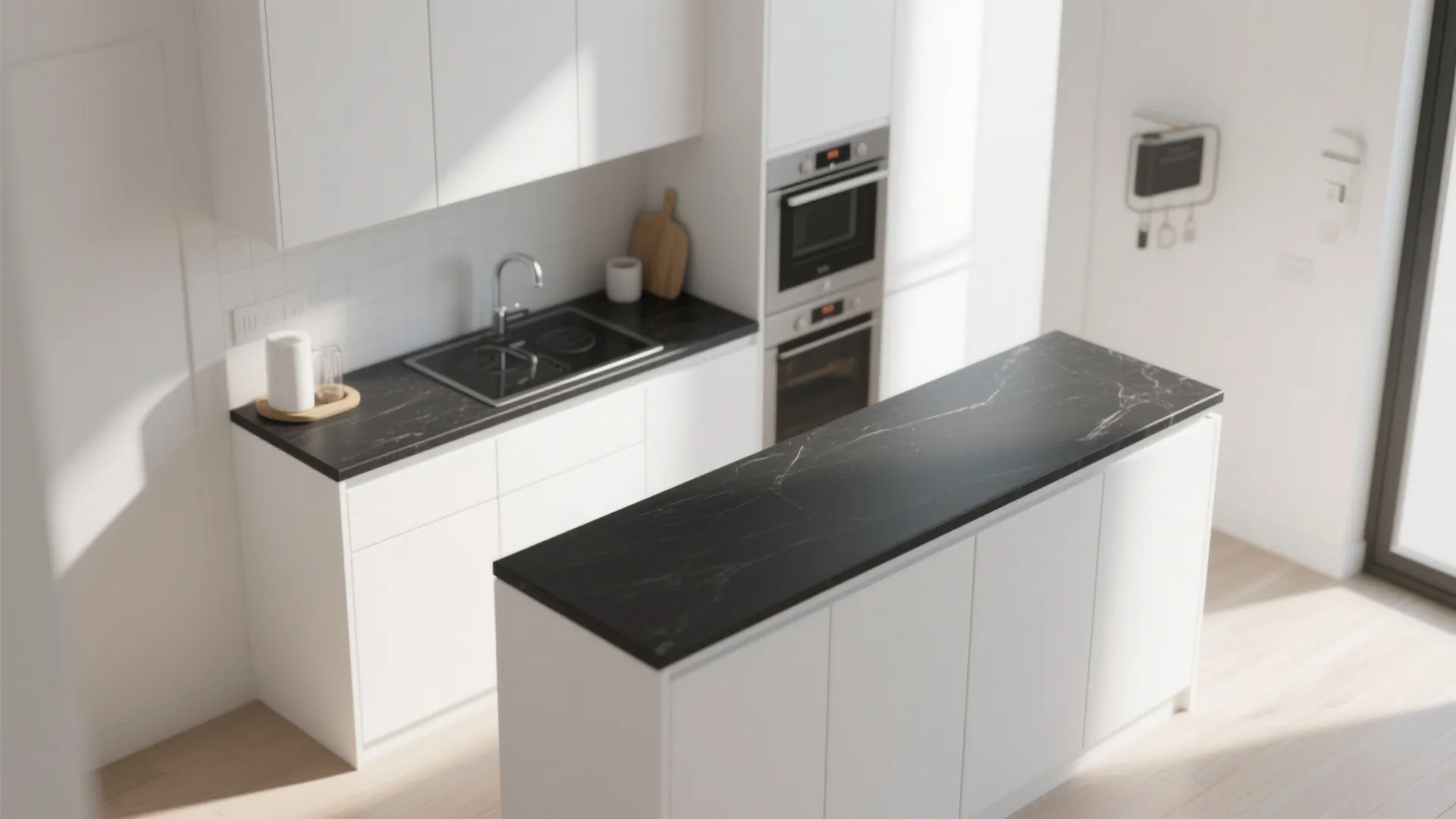 Top-down view of a small kitchen showing a thin black countertop edge over white cabinets.