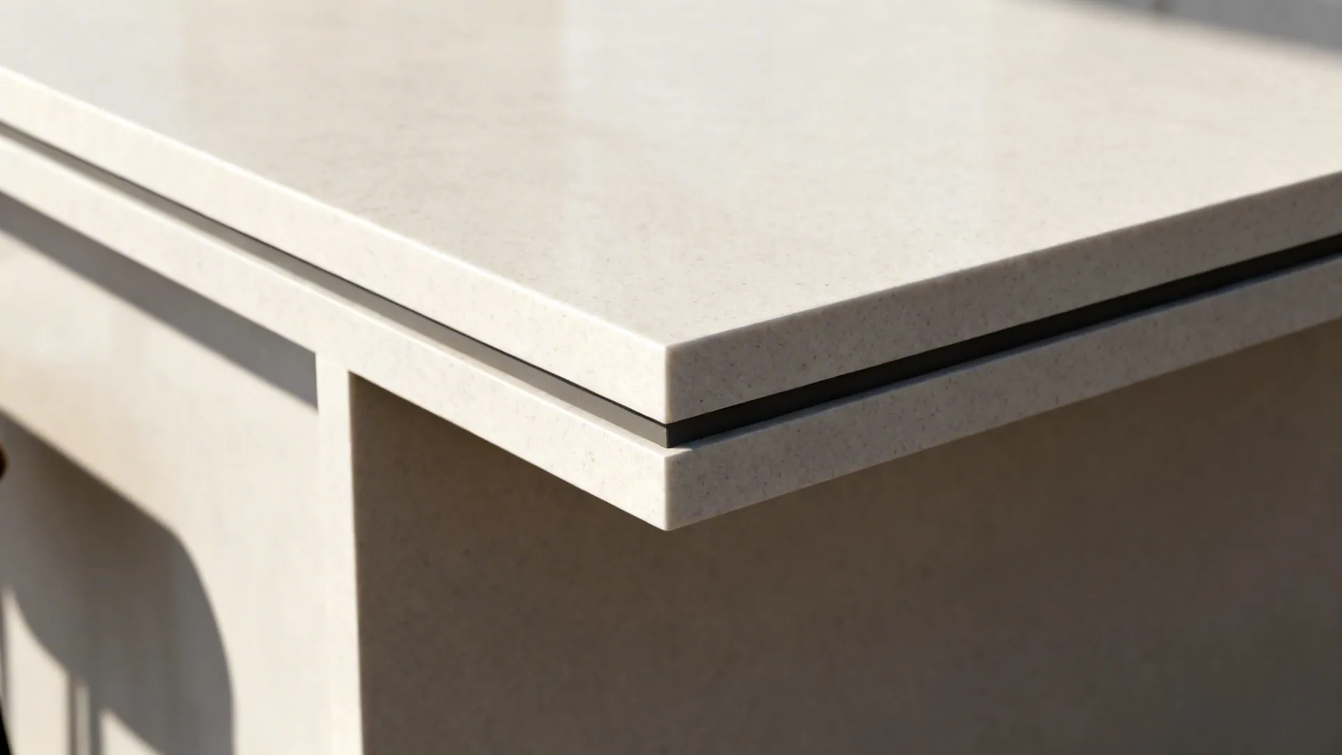 Close-up of a two-tier island edge showing thicker raised prep profile and precise transition.