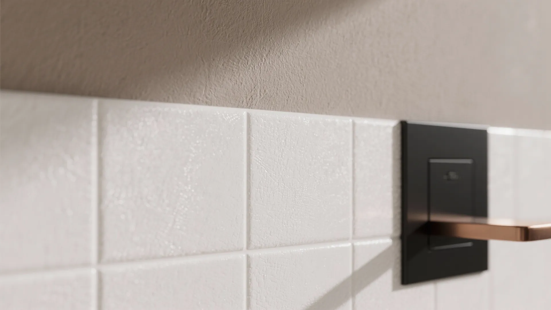 Macro of soft white porcelain tile with taupe wall and matte black flush plate.