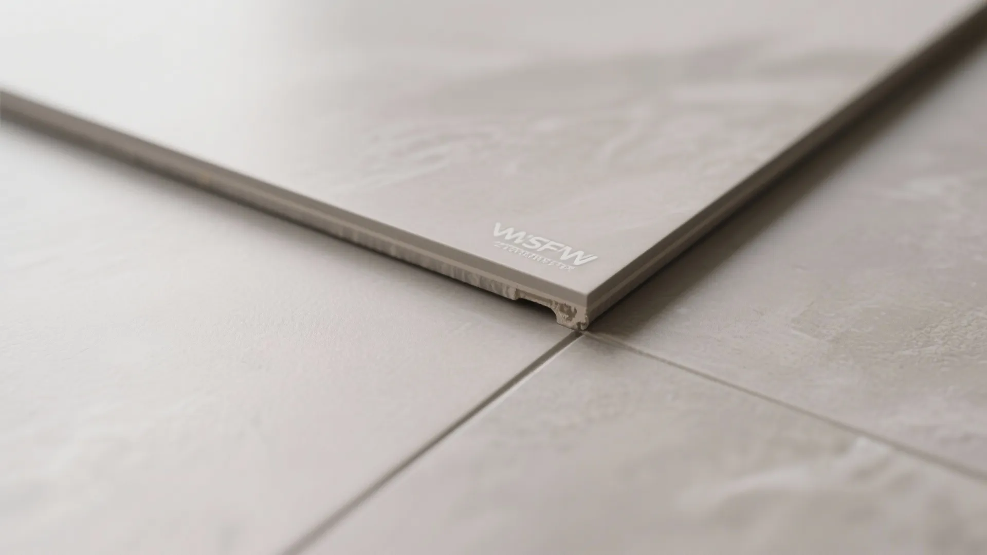 Close up view of floor tiles showing clean grout lines and smooth grey stone texture