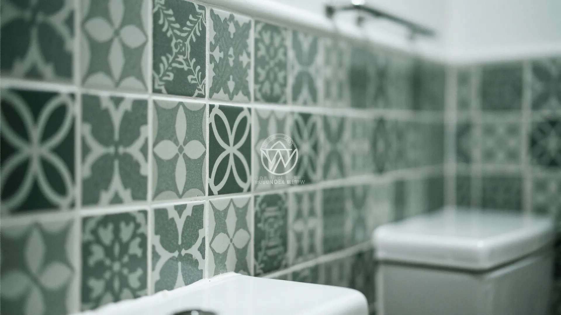 Close up of green and white patterned wall stickers behind a white bathroom sink area