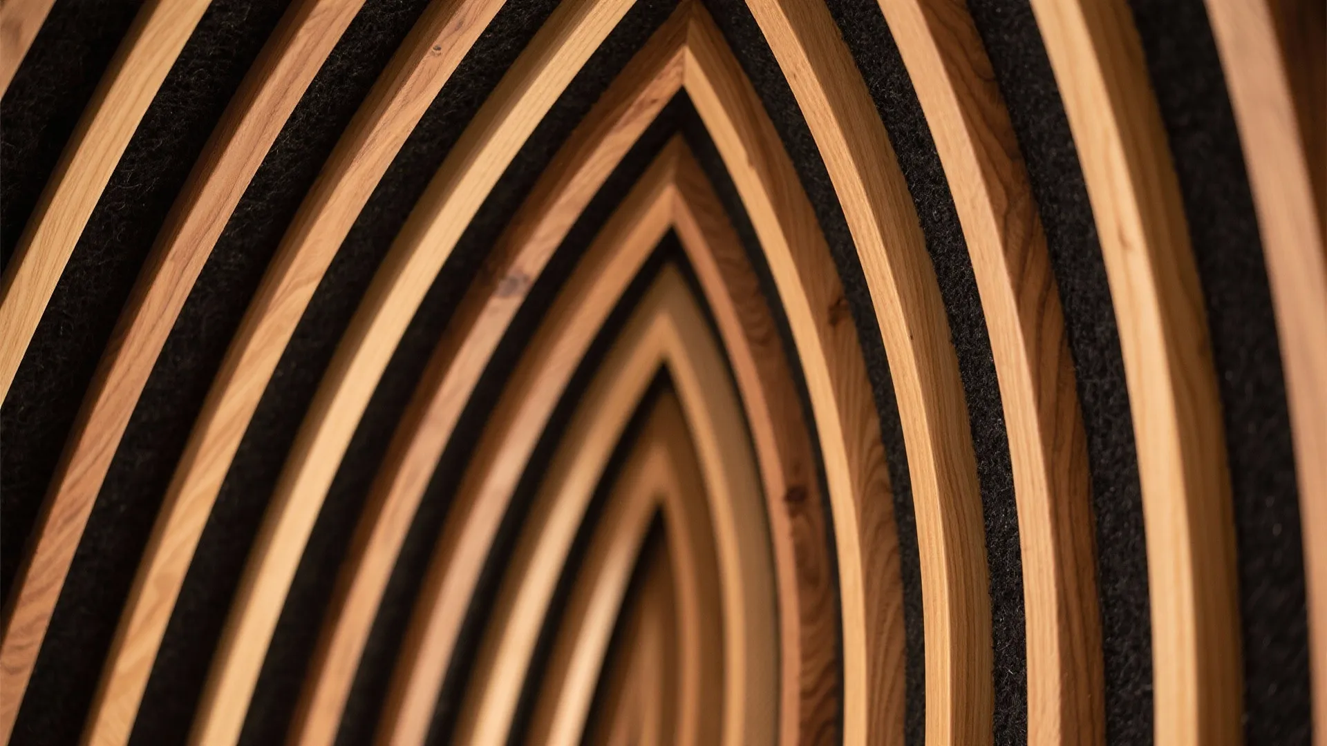 Macro detail of oak ribbed ceiling slats with black acoustic backing.