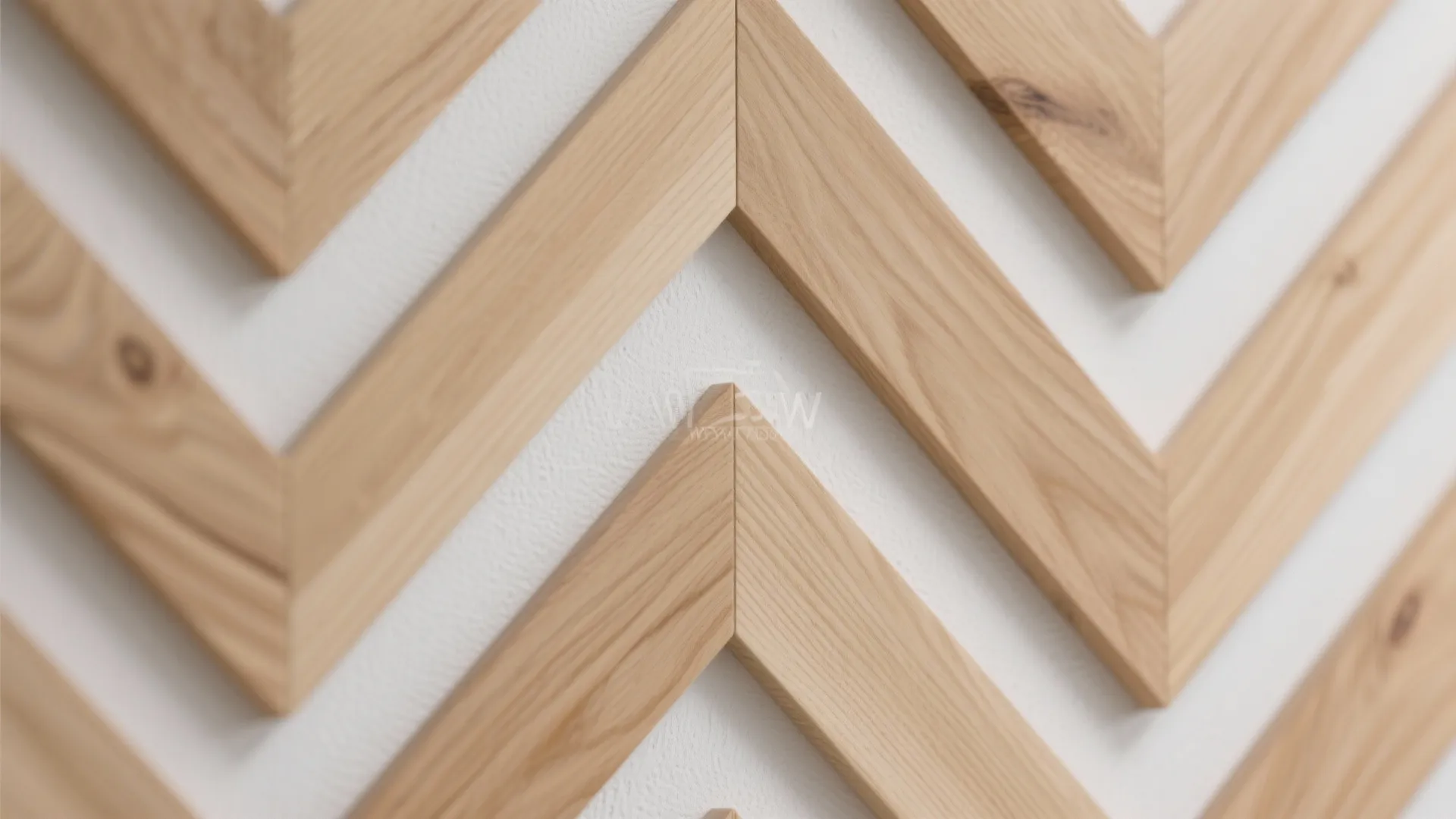 Close up view of light wood wall panel strips arranged in a repeating chevron pattern
