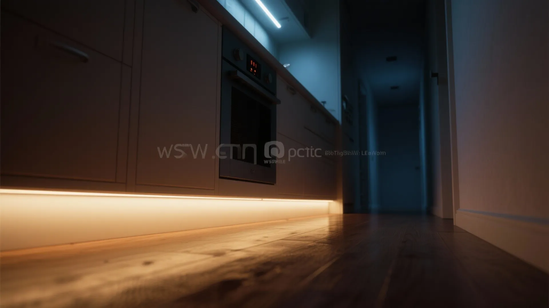 Low-angle view of toe-kick LED strips creating a warm floating-cabinet ambient glow and a night-time pathway light.