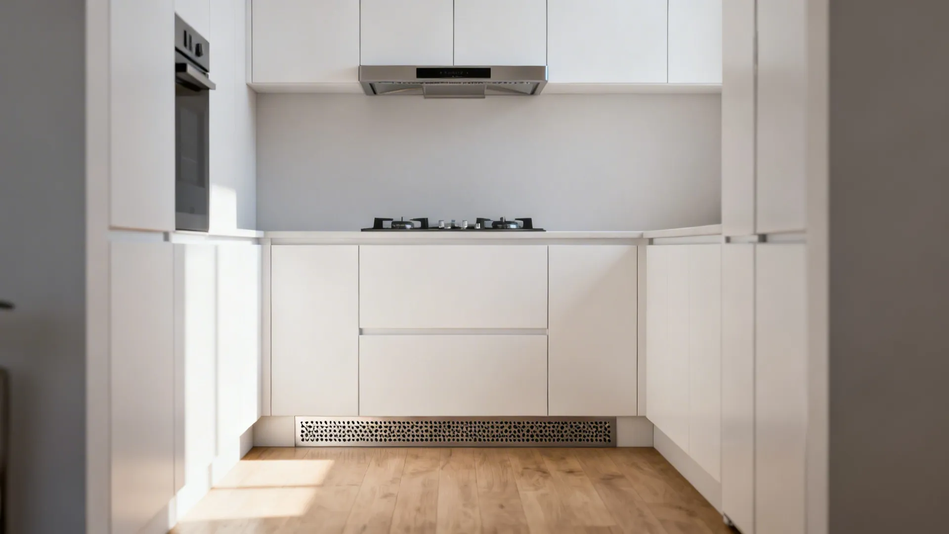 Modern white kitchen cabinets with stove and metal air vent in the floor toe kick area