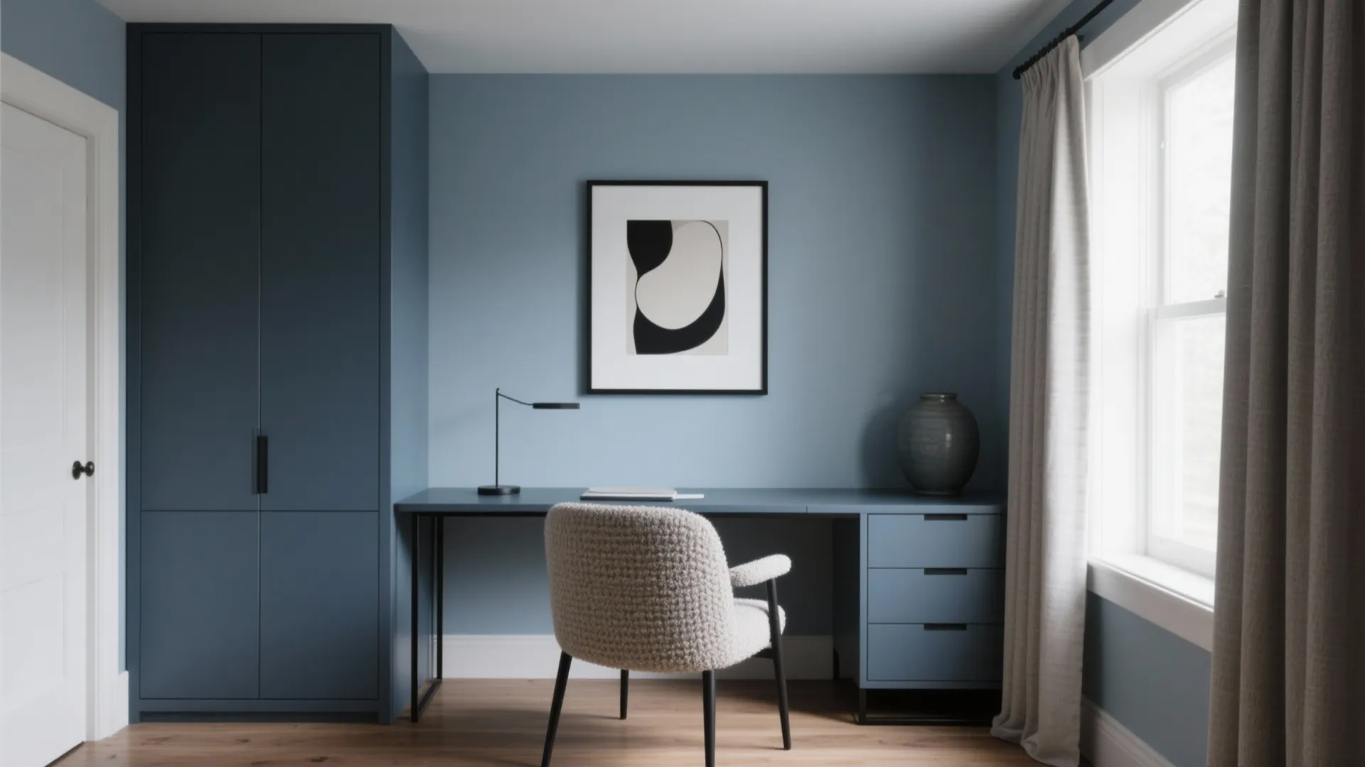 Blue home office room with a matching blue desk and tall cabinet and white chair