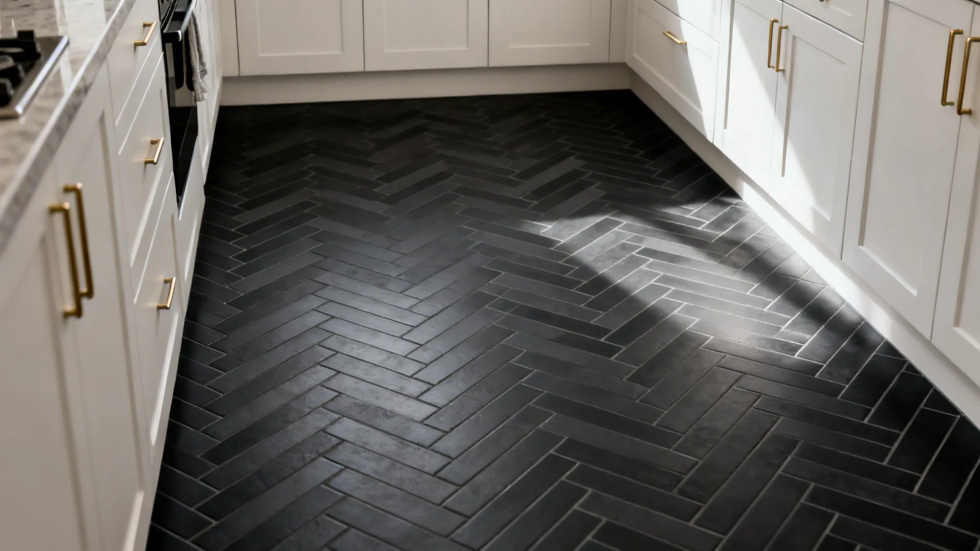 Tone-on-tone black tiles with subtle charcoal geometric pattern under soft daylight.