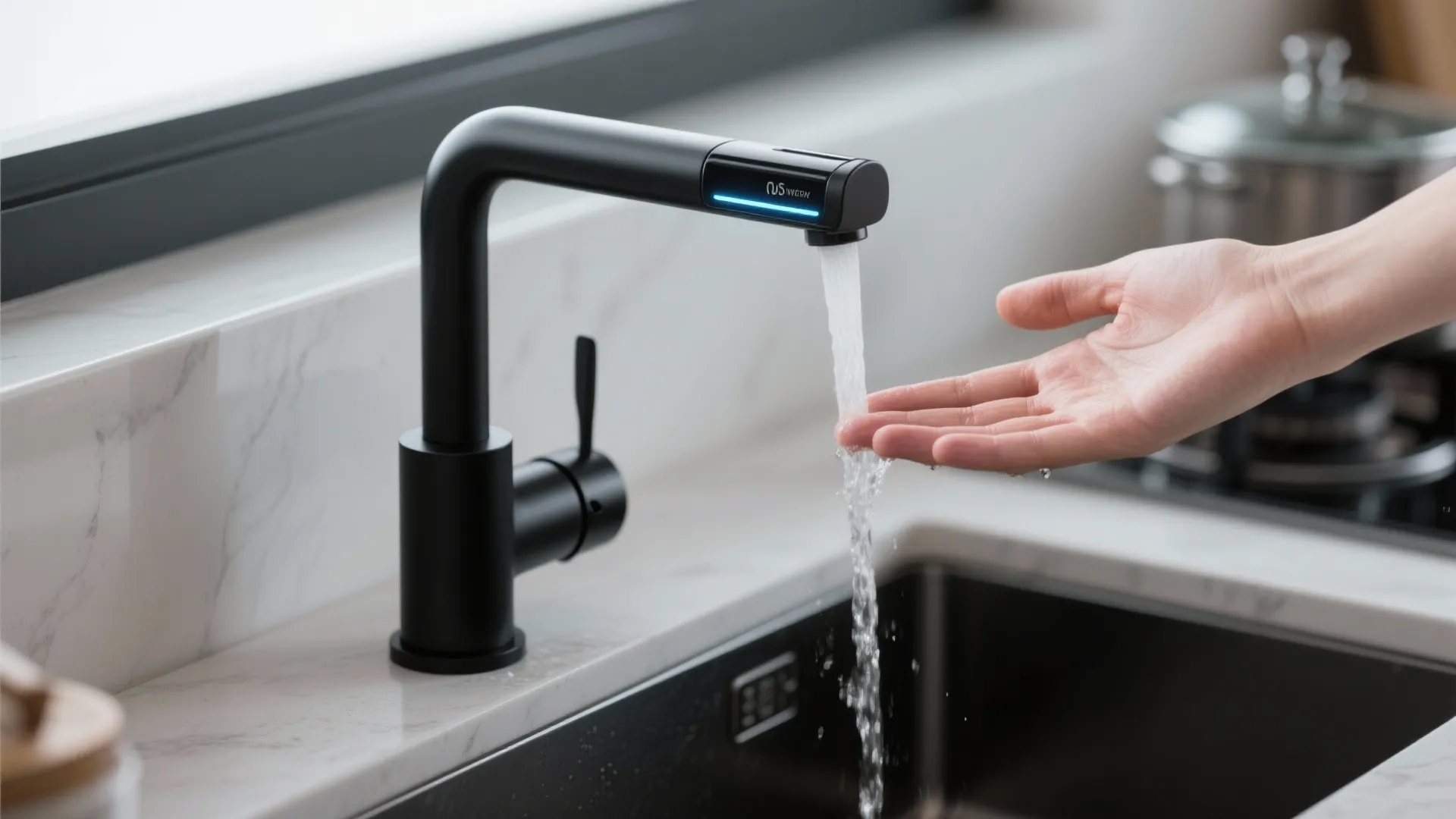 Modern black kitchen water tap with sensor display and water flowing over a person hand