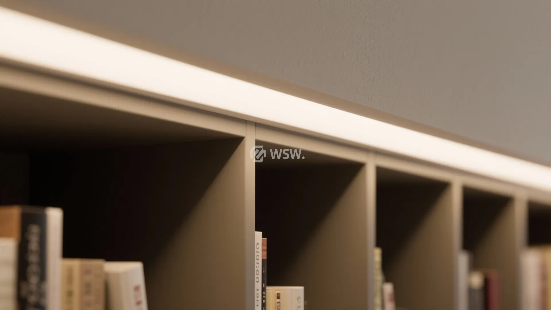 Close up of a bright white light fixture installed on top of a modern grey bookshelf