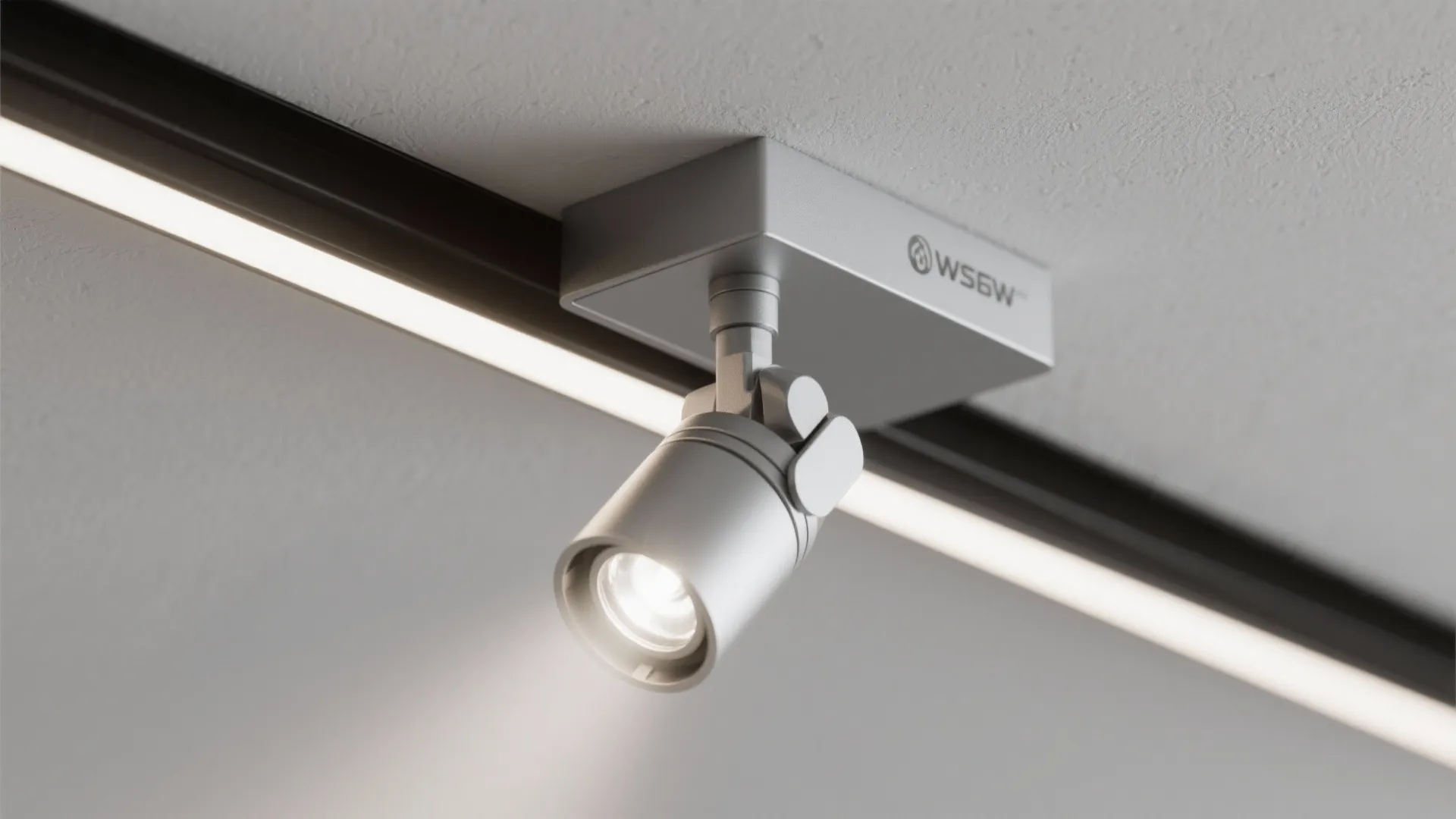 Adjustable white spotlight fixture mounted on a black track light system on a white ceiling
