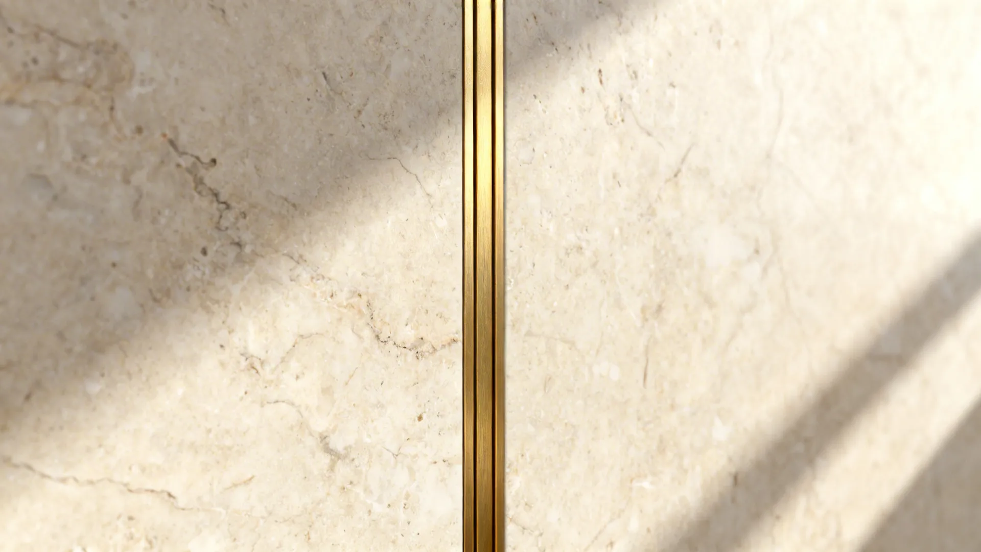 Macro of travertine-look laminate panel with a slim brushed-brass inlay.