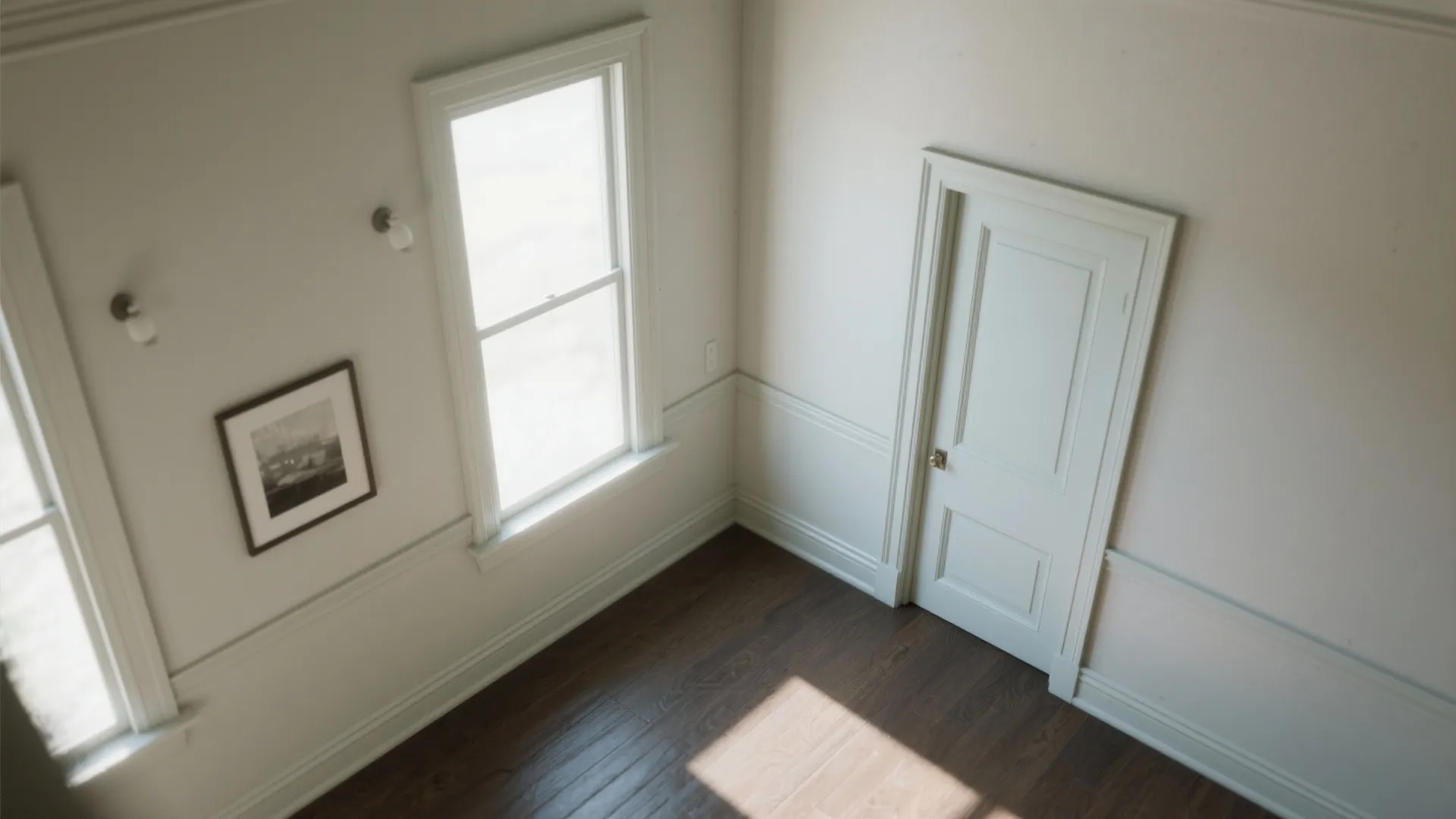 Empty white room with dark wood floor white door windows wall panel and wall lights