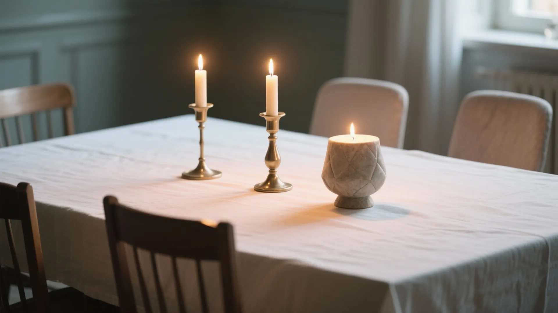 Three mixed-style candlesticks on rectangle dining table