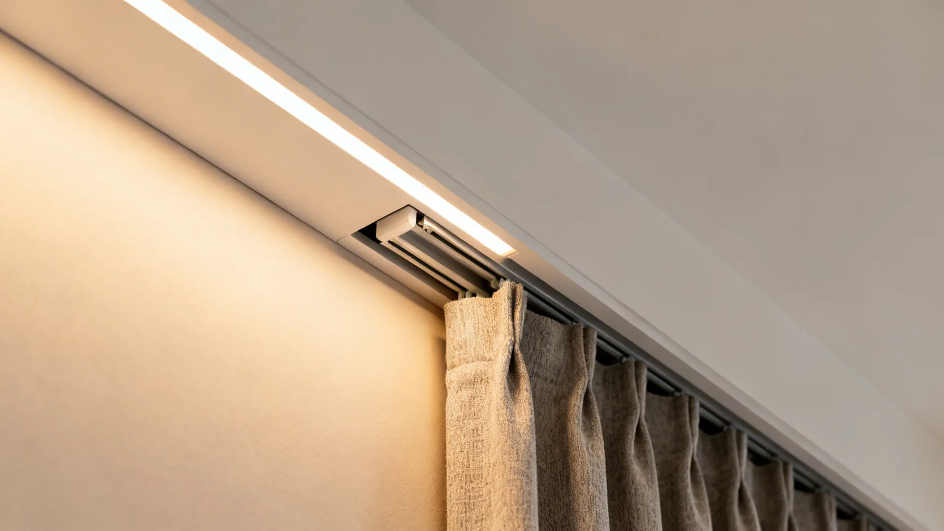Detail of a POP perimeter trough with concealed double curtain track and warm wash light.