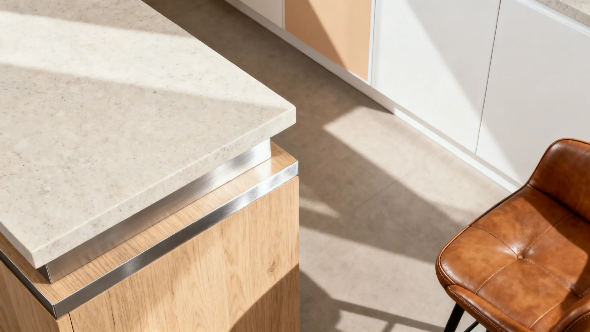 Material flat lay with light quartz, pale oak, brushed metal, warm white paint, and faux leather.