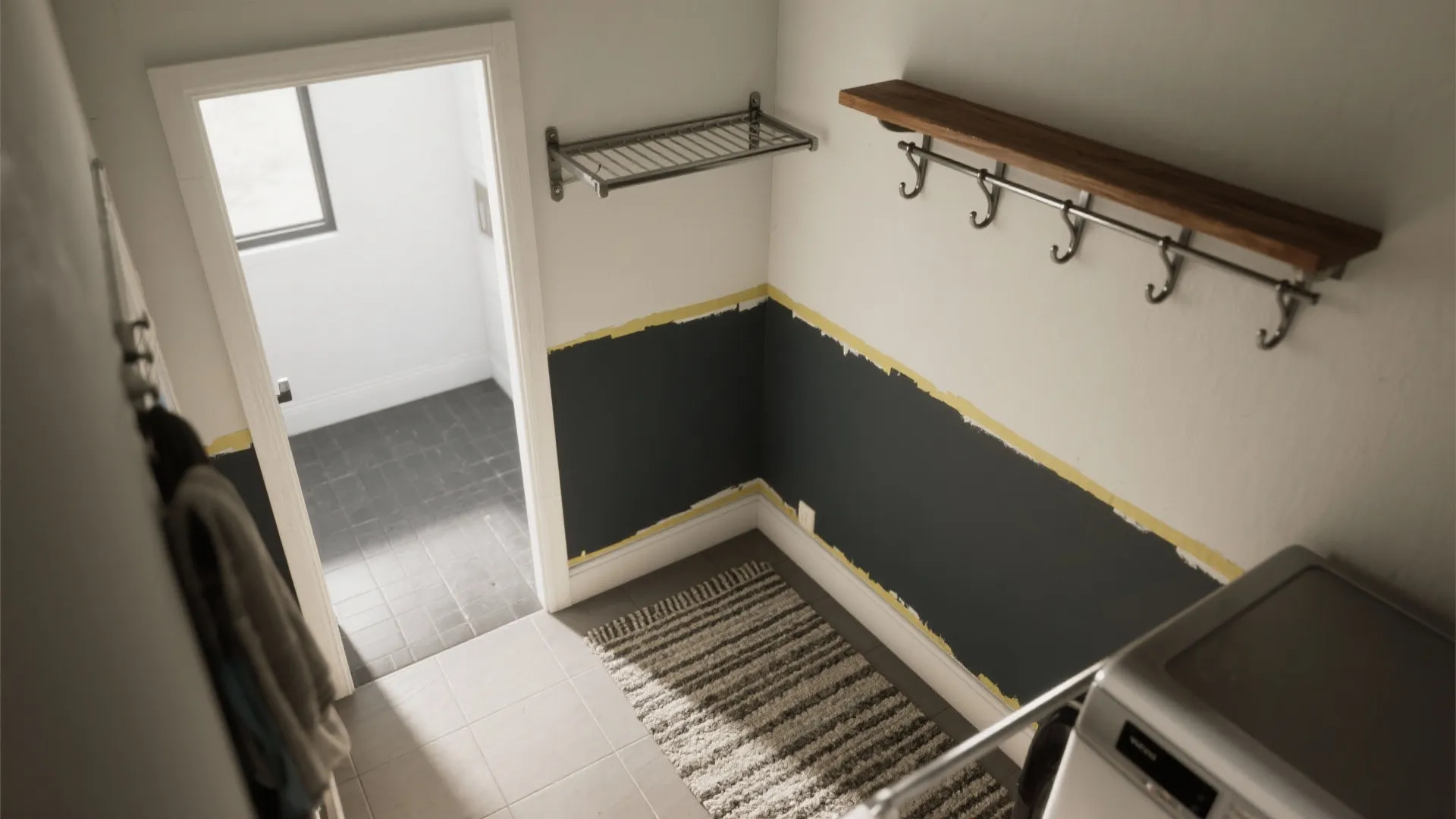 Laundry room wall showing two tone paint design with dark grey bottom and white top half