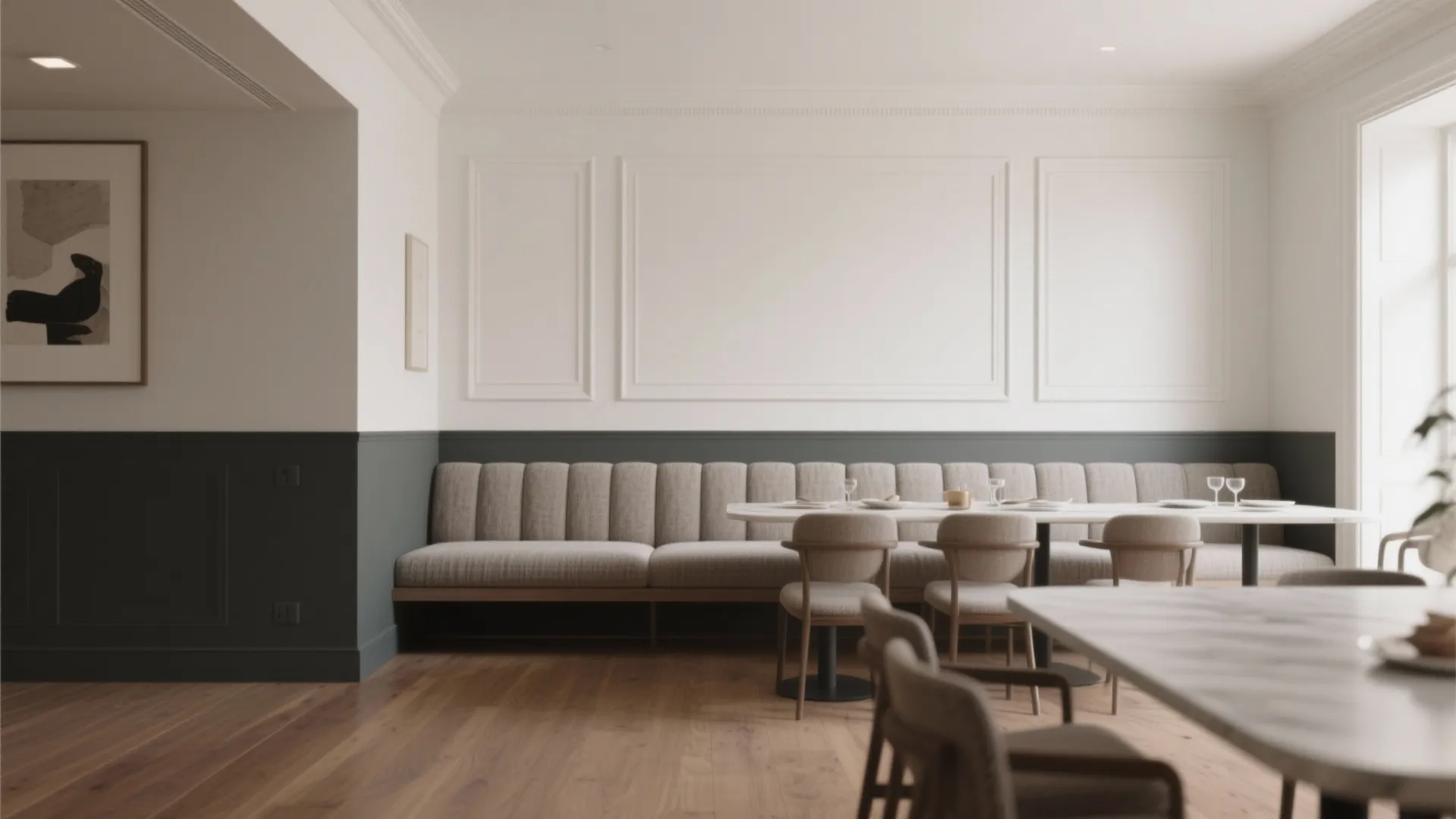 Dining area with white wall panels grey lower wall long bench sofa and wooden floor