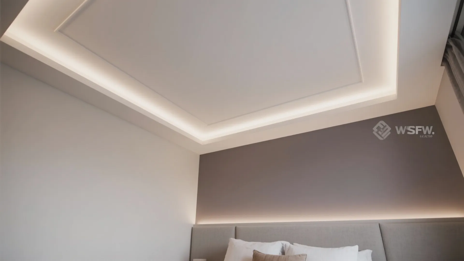 Modern bedroom with white tray ceiling lighting above a grey wall and light grey bed