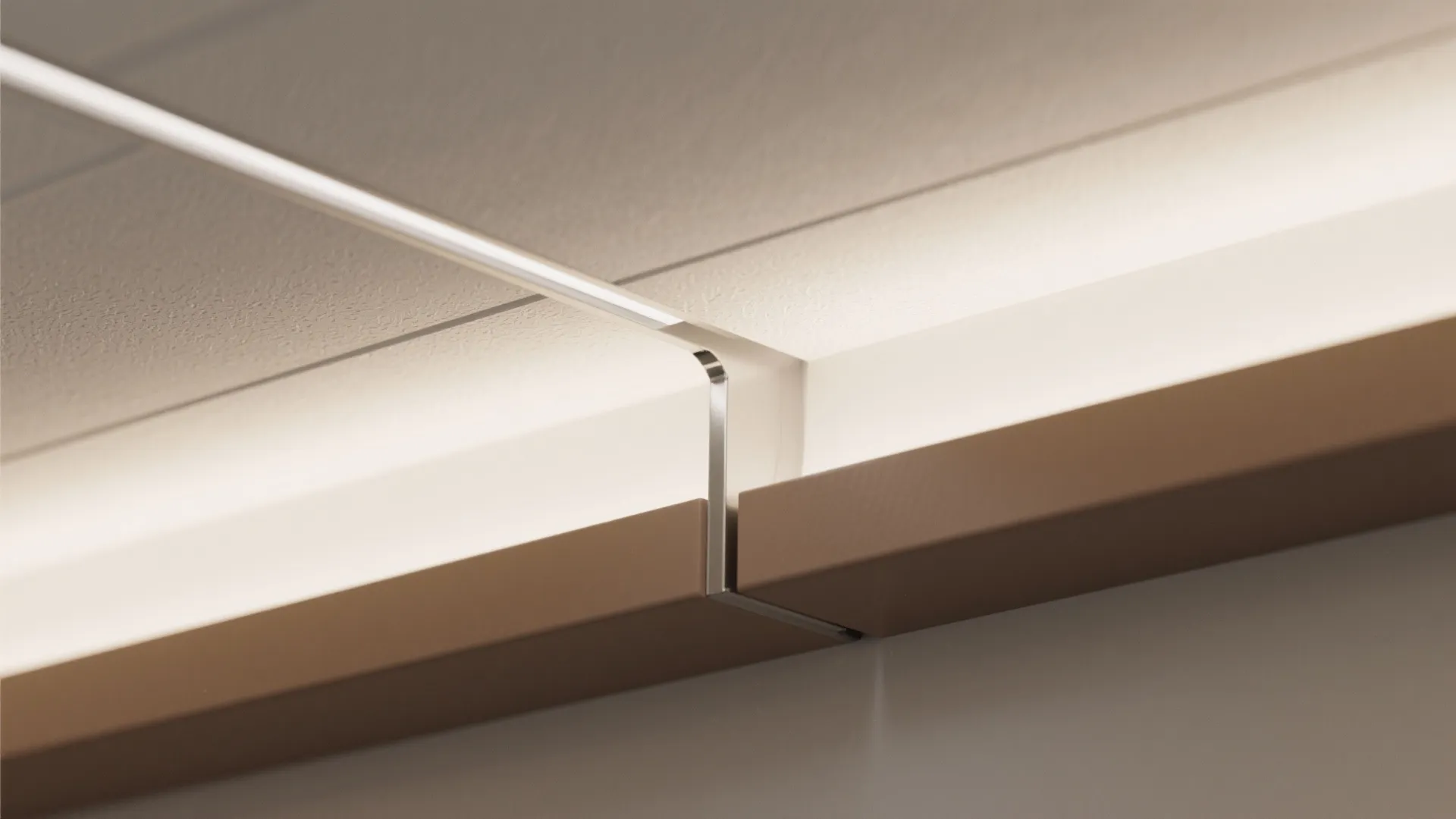 Macro view of two-tone PVC ceiling junction with recessed LED channel and clean seam.