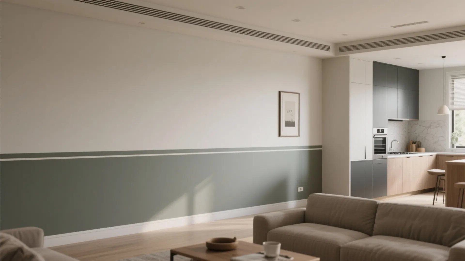 Open-plan interior with a horizontal two-tone wall and thin picture rail visually anchoring furniture.