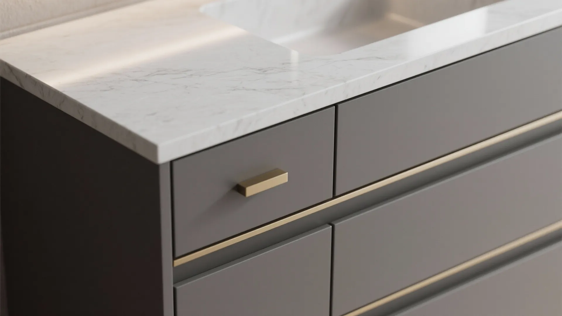 Two-tone gray vanity close-up showing charcoal base and dove-gray countertop with brass pull