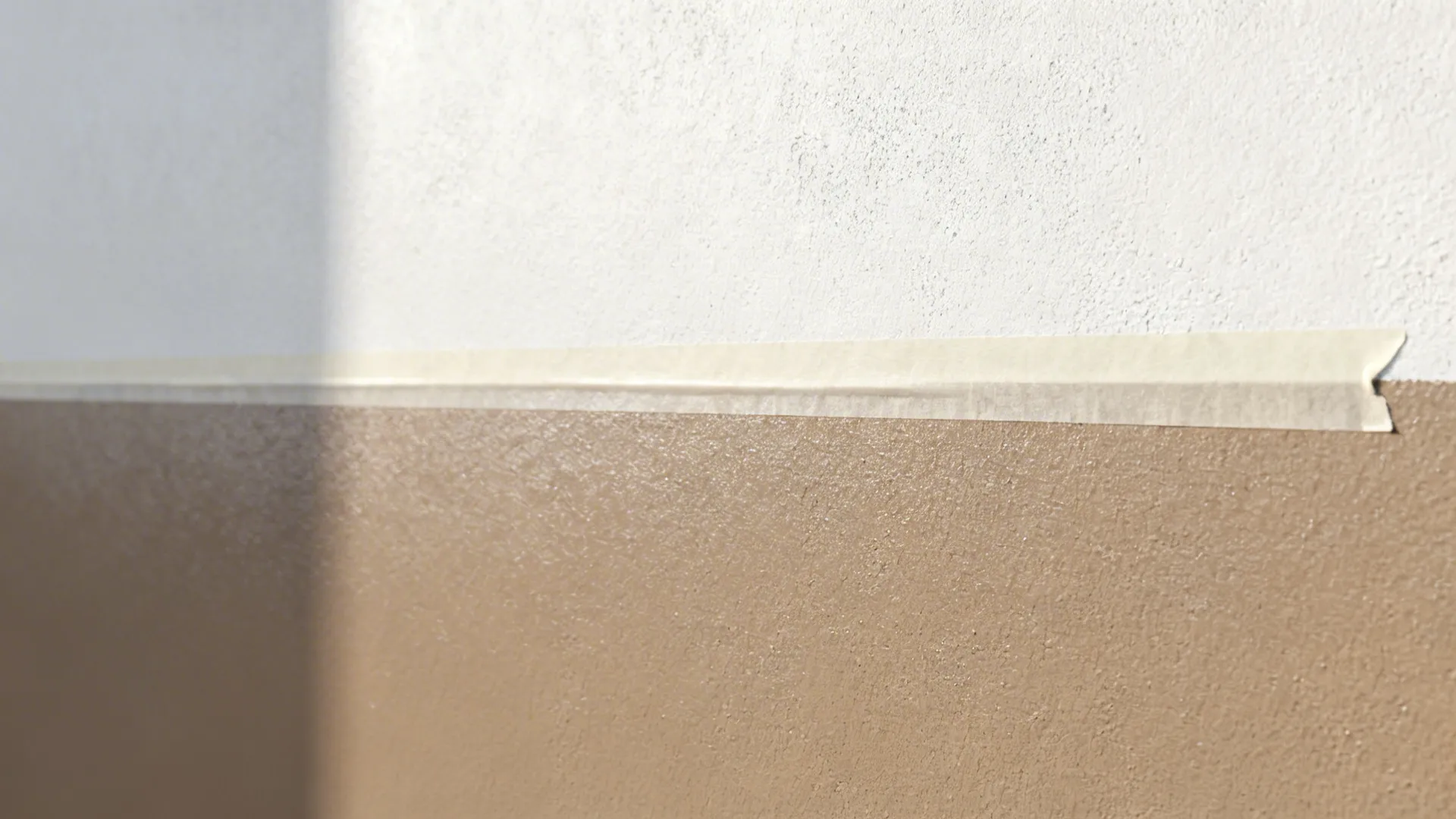 Macro of crisp two-tone wall line with taupe satin below and soft white matte above.