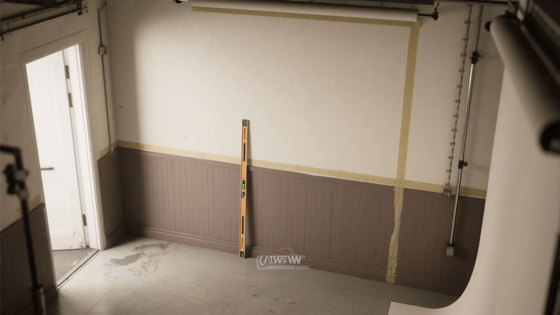 Interior room under renovation with brown wall panels tape markings level tool and white studio backdrop
