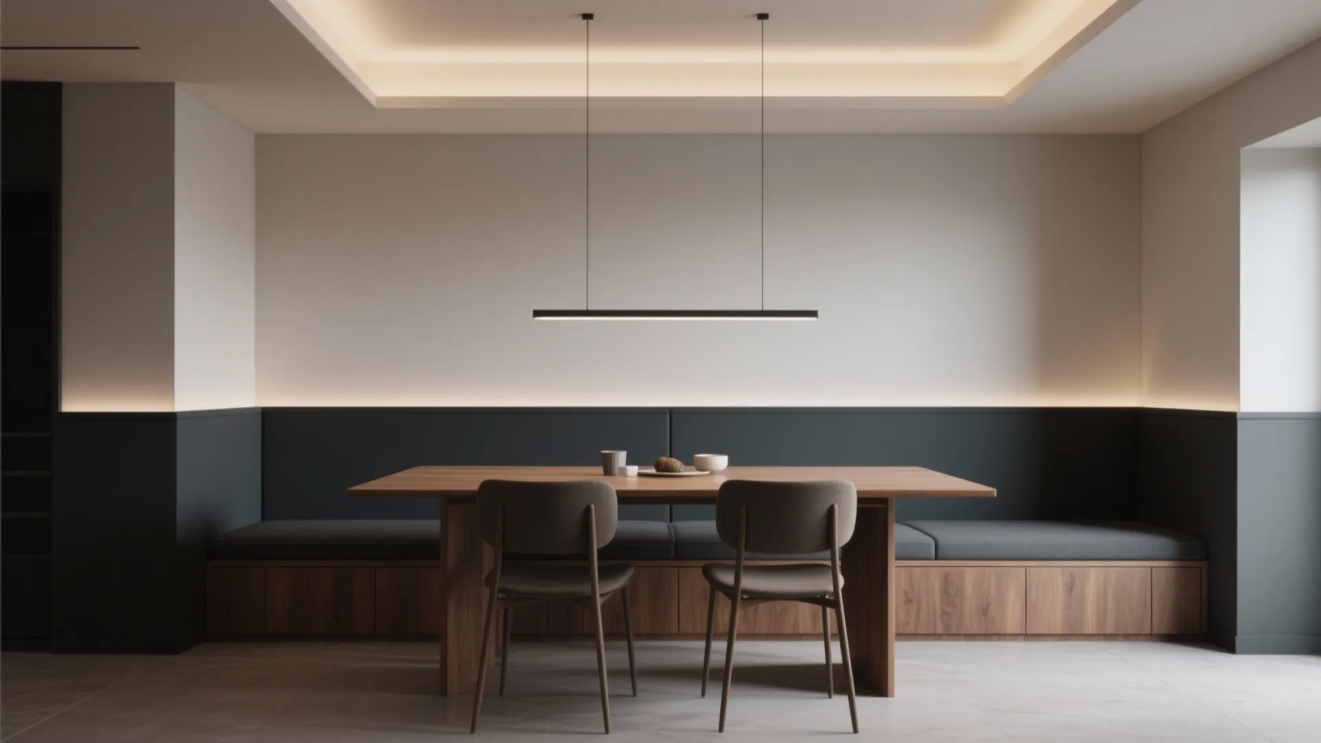 Modern dining room with two tone walls wooden table grey bench seating and black ceiling light