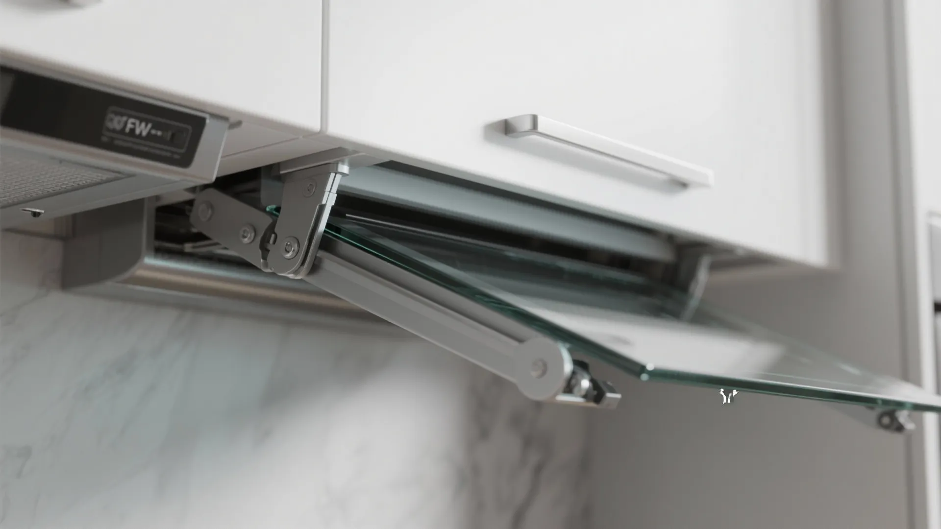 Close-up of an under-cabinet pop-up TV mechanism with splashproof casing and metal lift hardware.