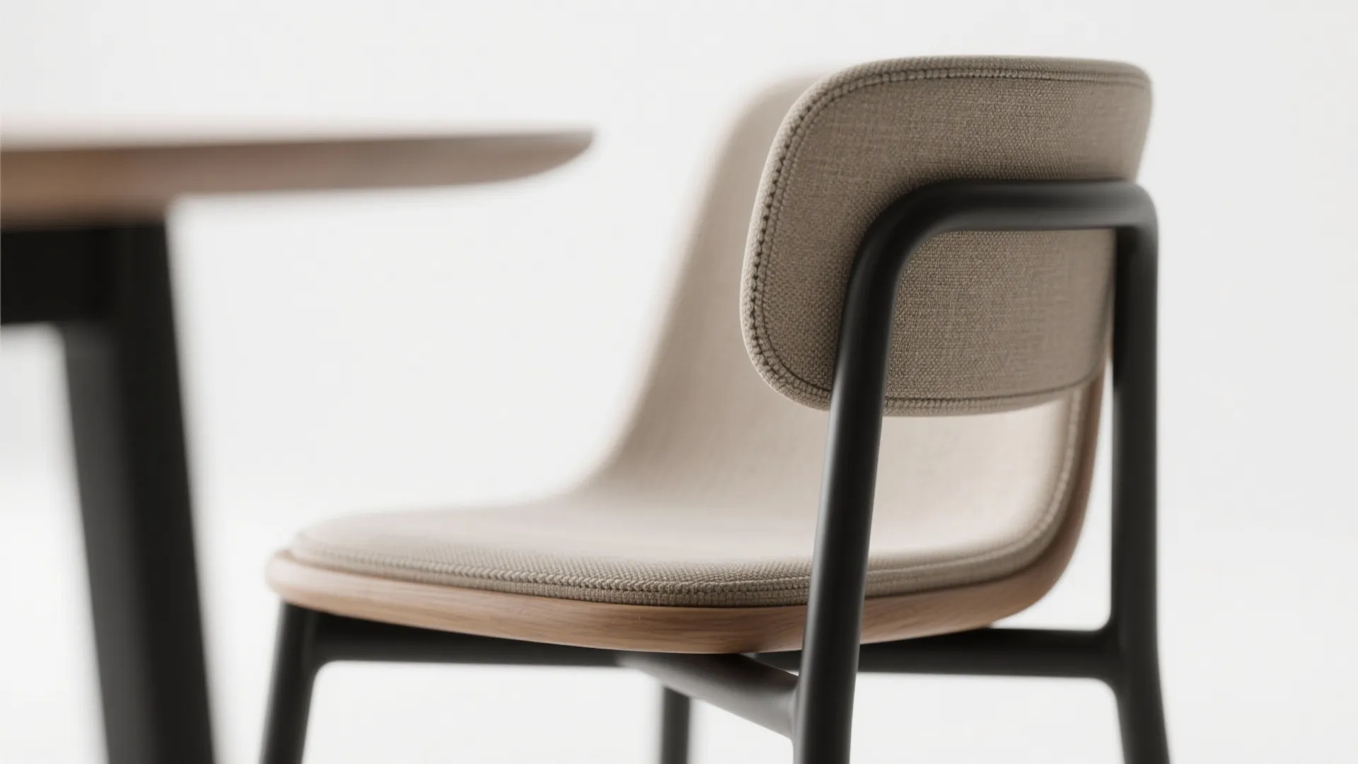 Close up of a modern chair with beige fabric seat and black metal frame design