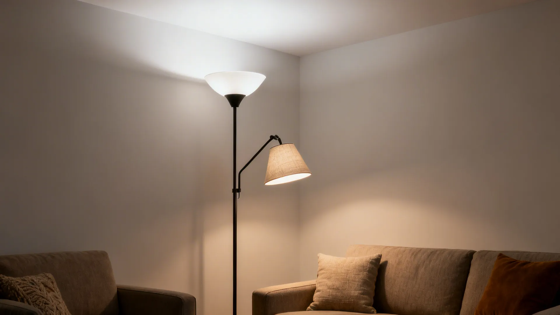 Dual-head floor lamp uplights a matte ceiling while a reading arm handles tasks.