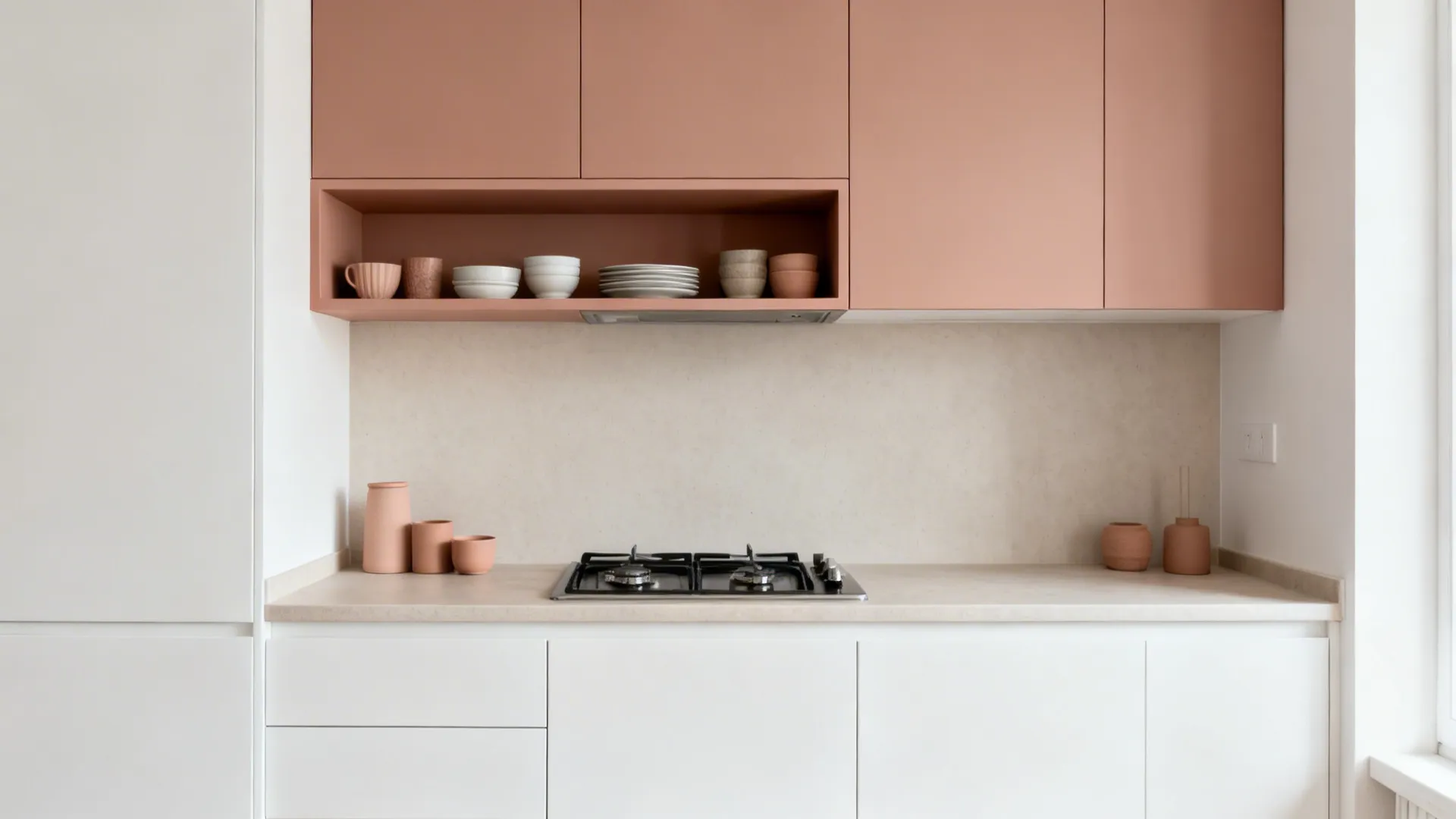 Minimalist kitchen with pink upper cabinets white lower cabinets gas stove and ceramic bowls on shelf