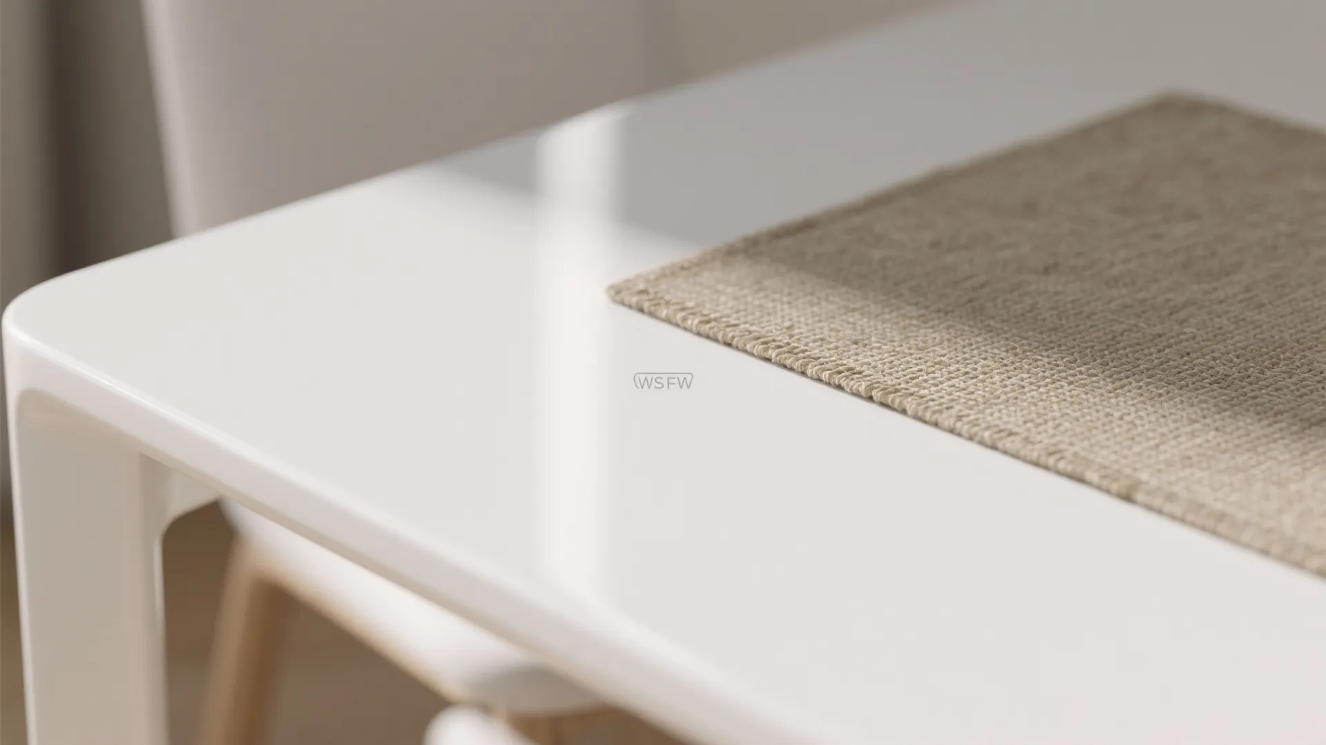 Macro shot of a shiny white dining table surface with a beige woven fabric placemat