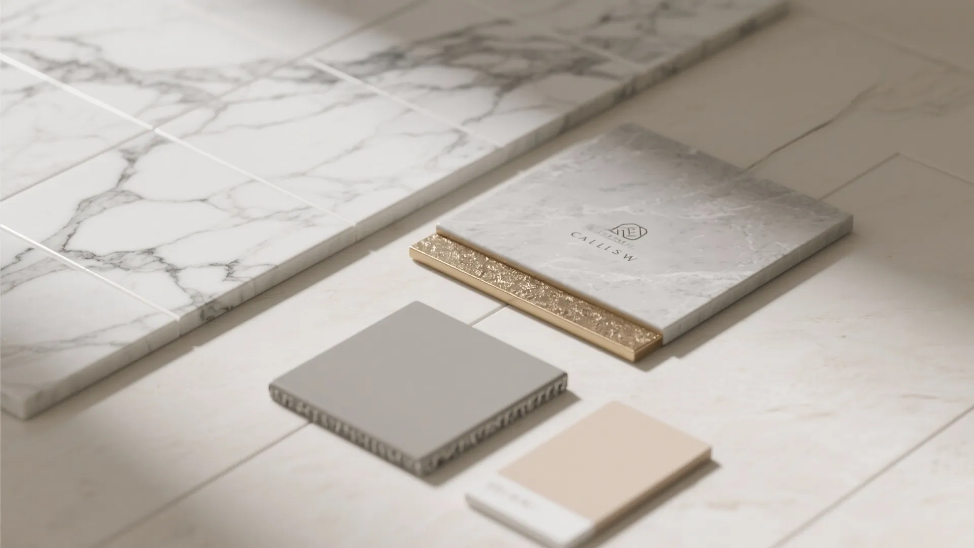 Flatlay of bold-veined porcelain, matte floor tile, brass trim, and grout swatches.