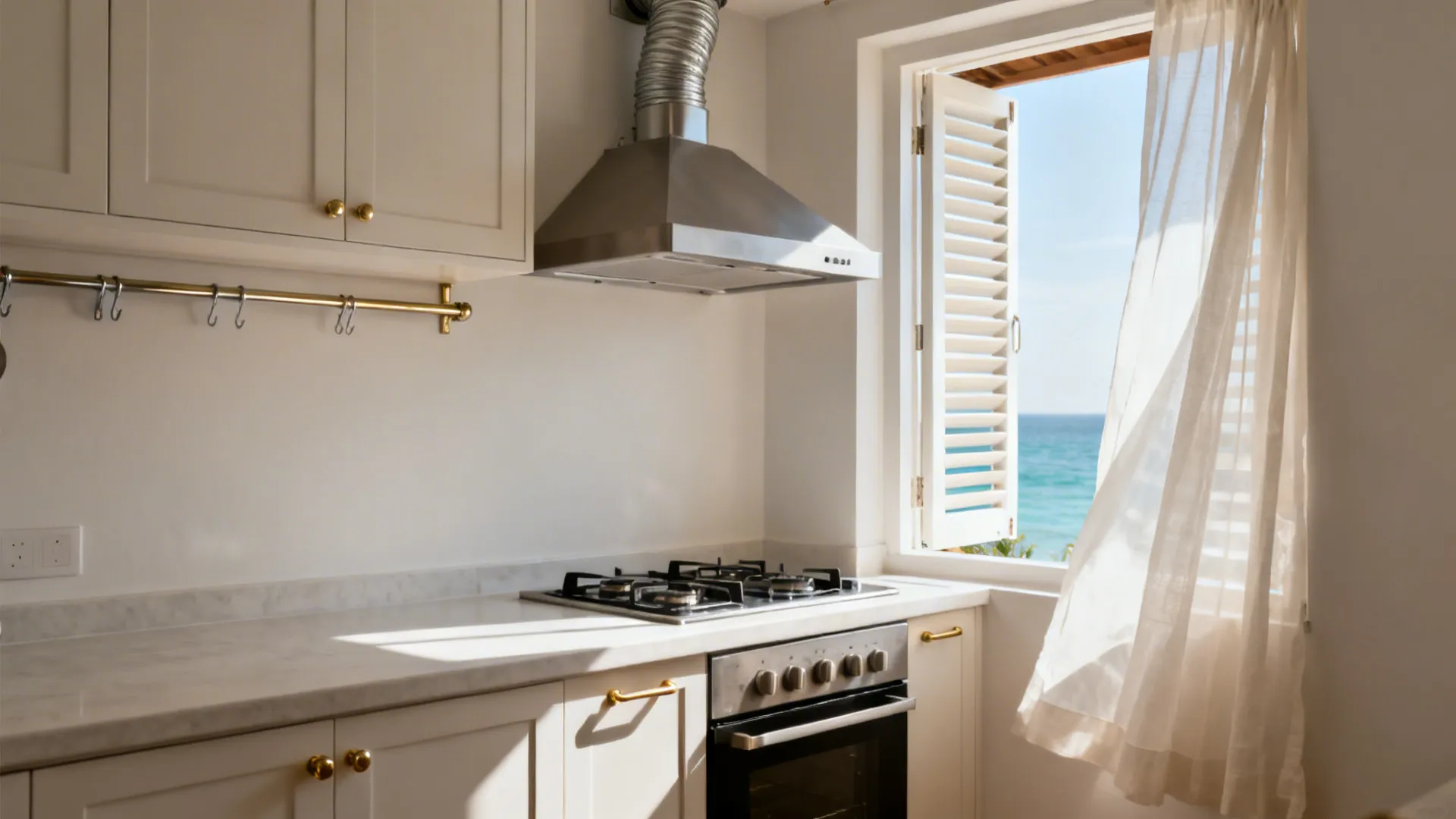 Ducted chimney over the hob and a louvered window creating cross-ventilation in a Kerala kitchen.