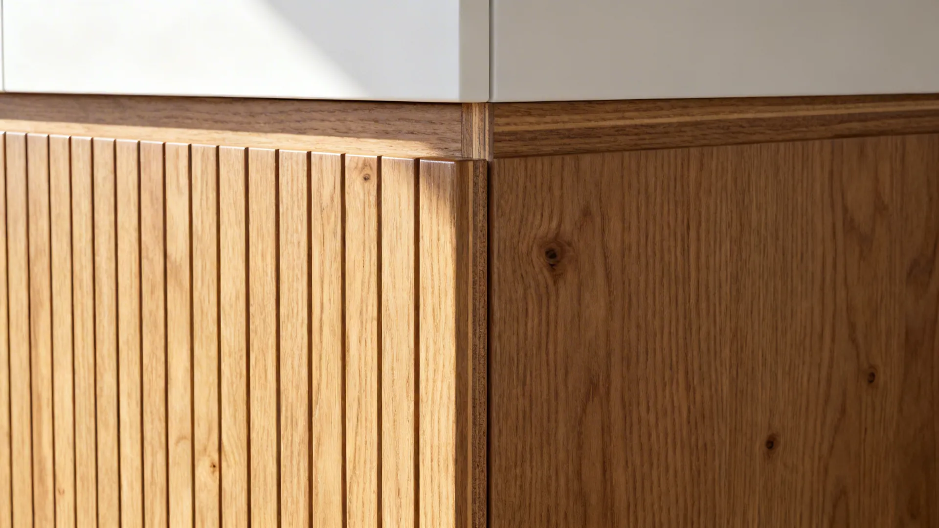 Close up of wooden cabinet with vertical lines and smooth wood panel under white kitchen counter
