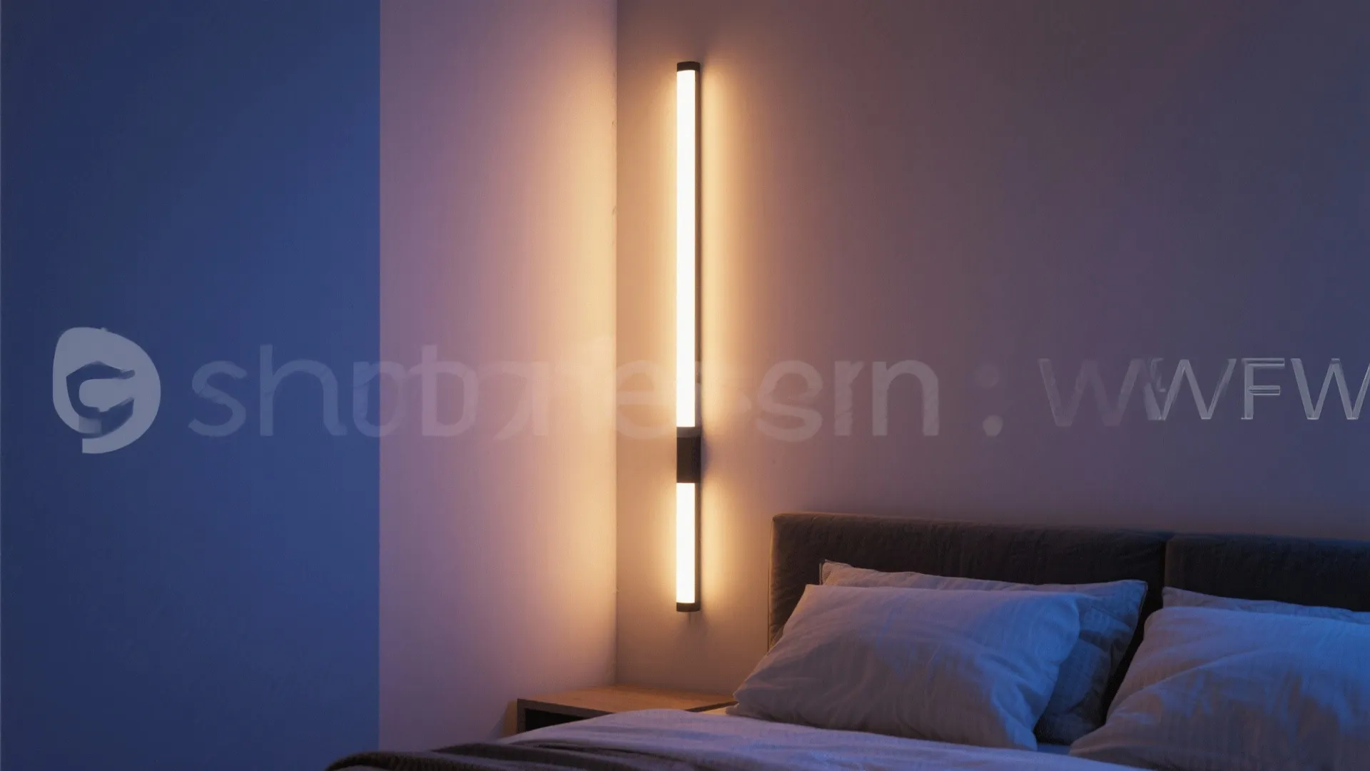 Modern bedroom with vertical wall light glowing beside a bed with white pillows and blankets