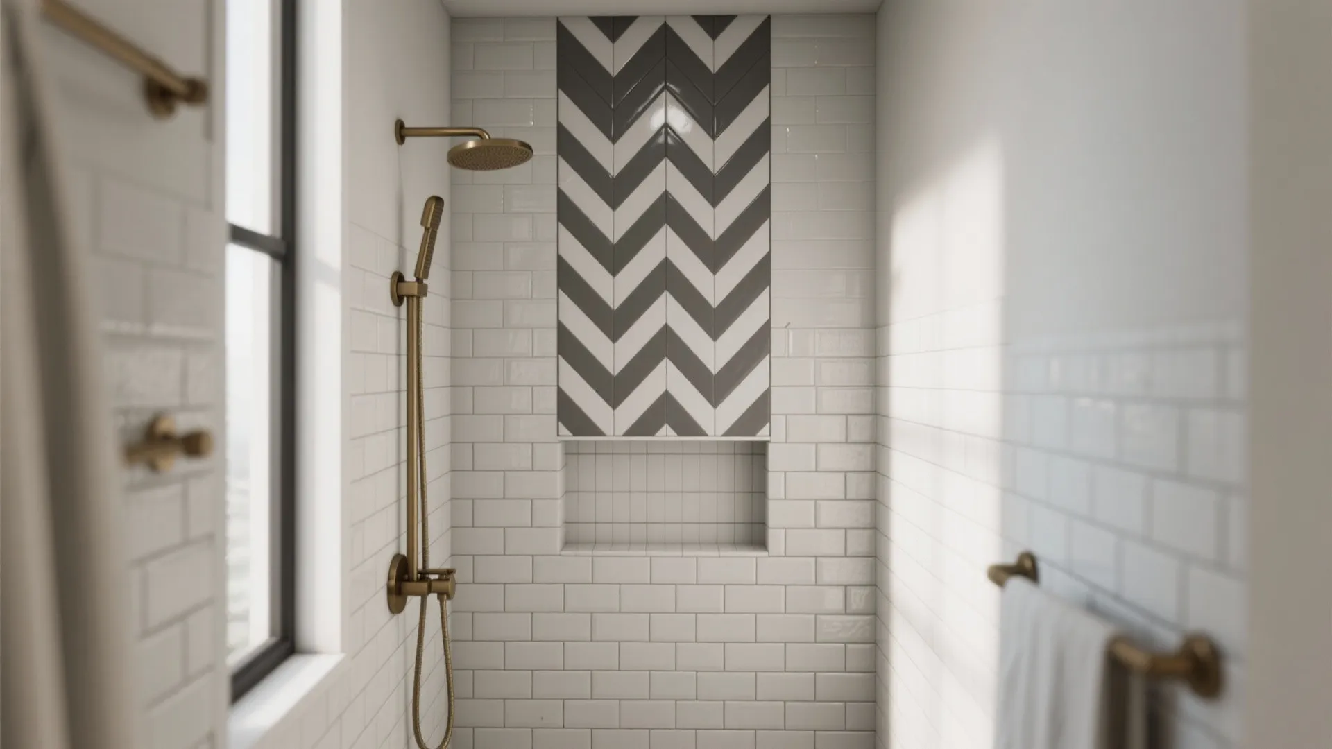Shower area with white wall tiles a grey pattern design and gold shower head fixtures