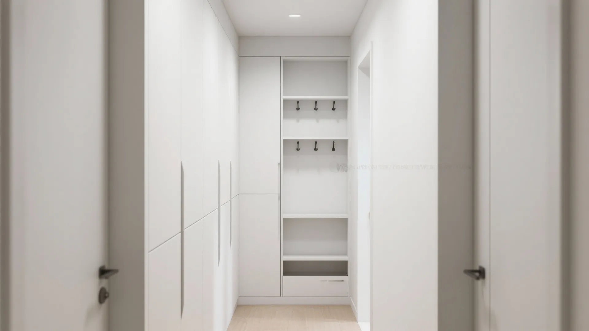 Modern white hallway featuring built-in storage cabinets with black wall hooks and wooden floor design