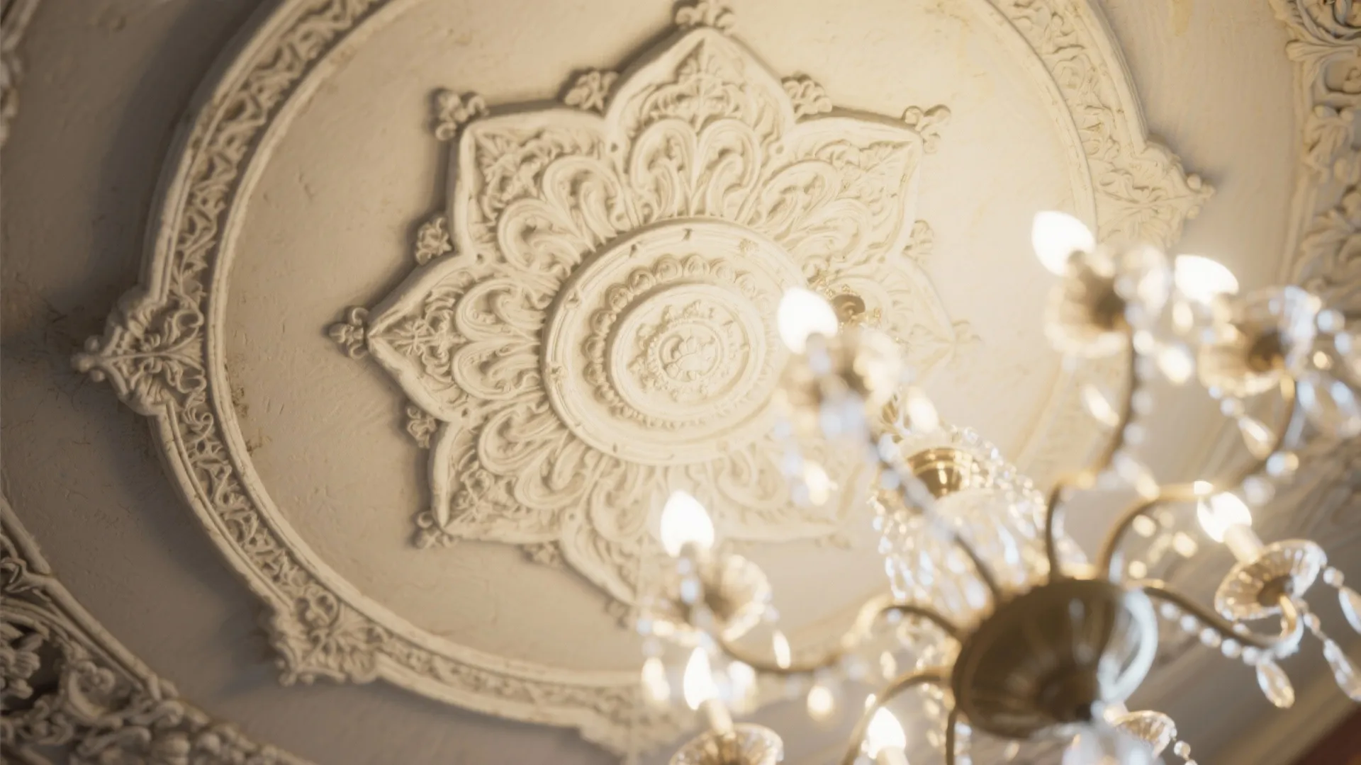 Close up of a decorative white ceiling pattern with a bright crystal ceiling light fixture