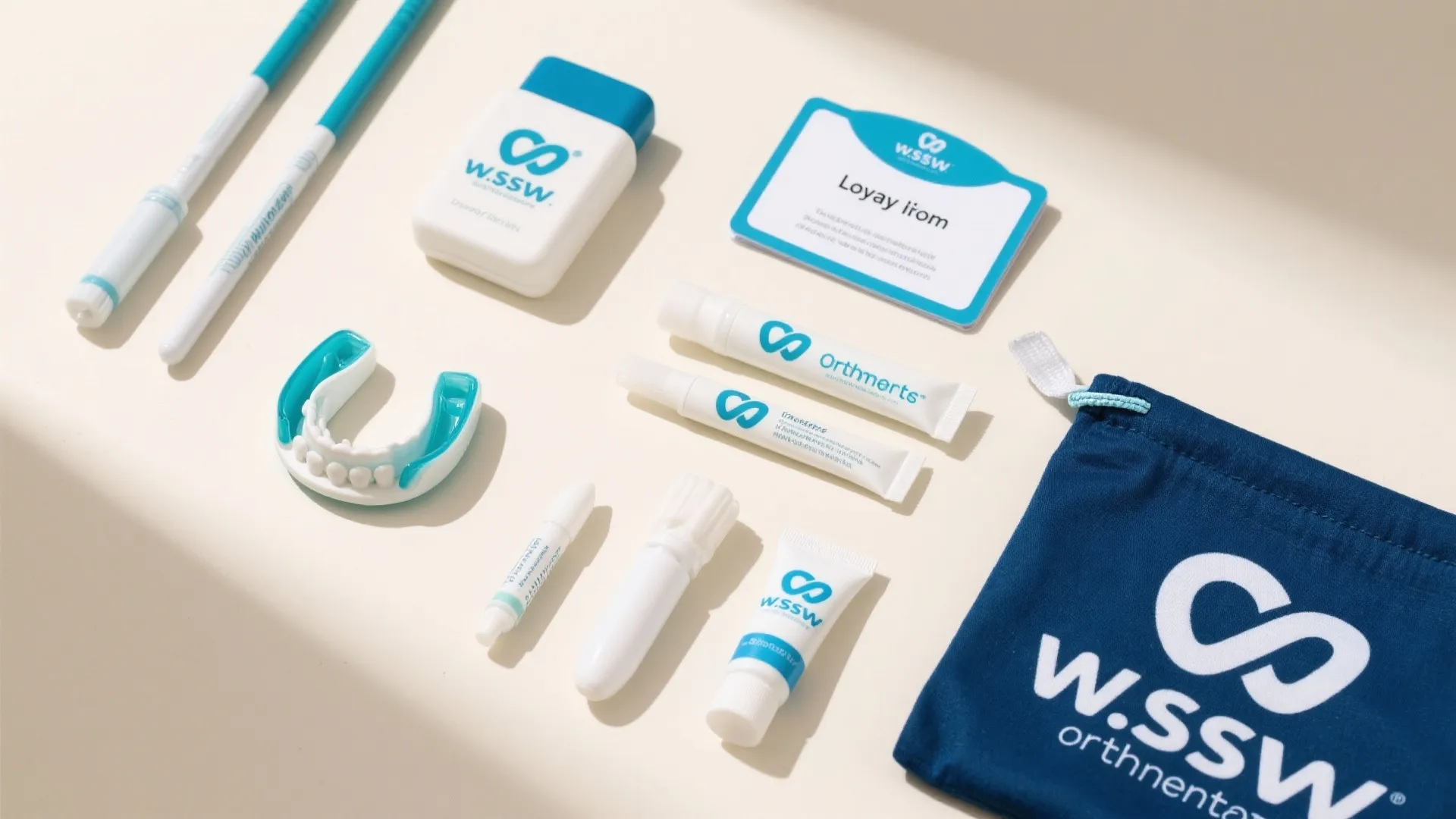 Teeth cleaning kit with white tubes and blue bag on a cream table with soft light