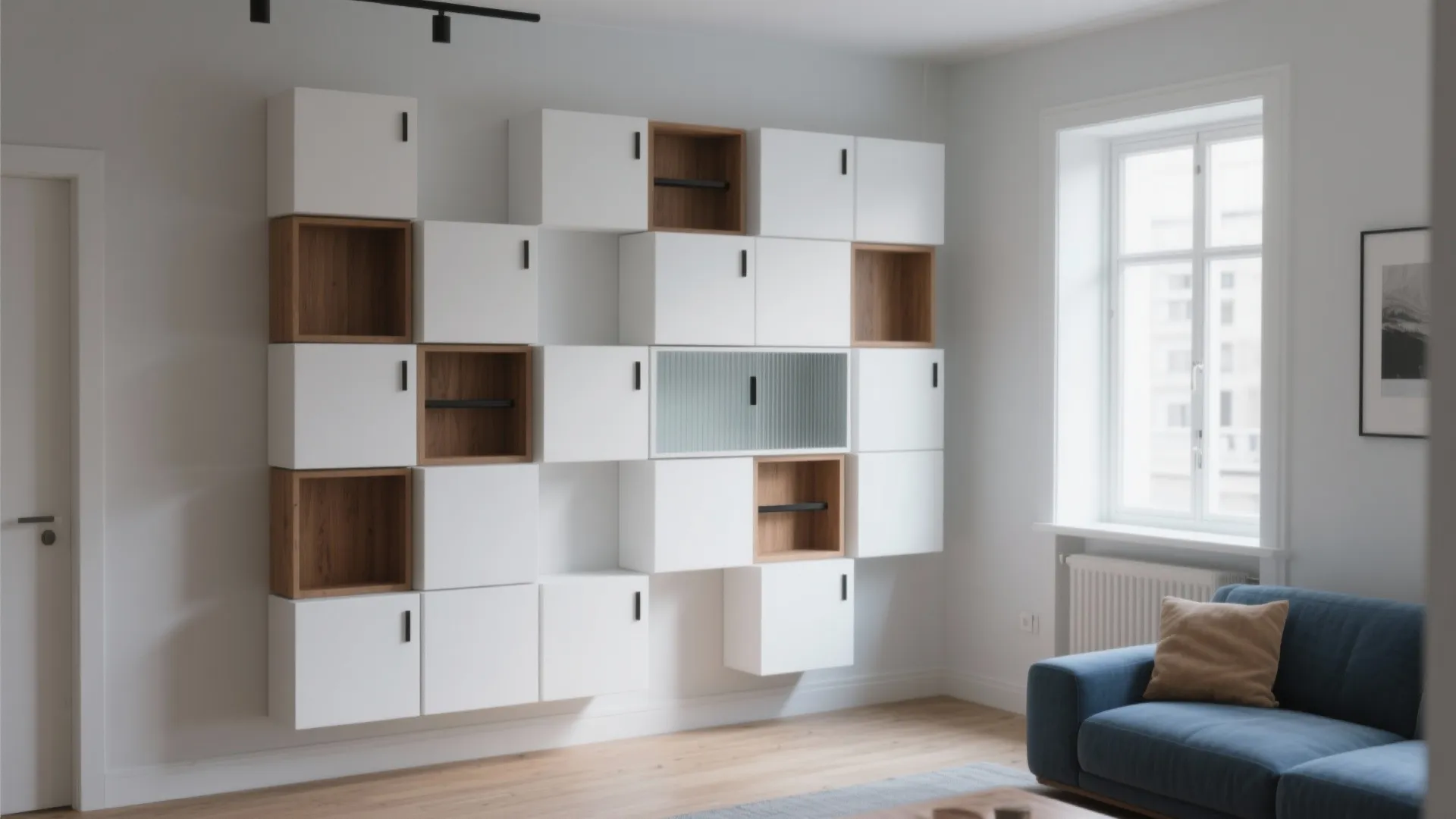 Modern living room featuring modular wall cabinets in white and wood with a blue fabric sofa